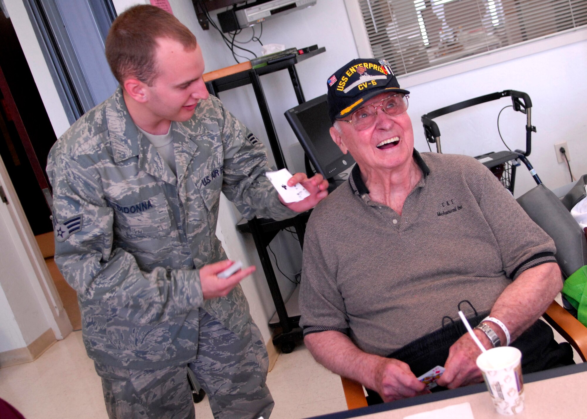CANNON AIR FORCE BASE, N.M. -- Senior Airman Steven Didonna, 27th Special Operations Logistics Readiness Squadron, plays cards with Jack Husband Aug. 28 at the Amarillo, Texas, Veterans Hospital. The visit was organized by the Middle Tier, who visits the hospital quarterly. (U.S. Air Force photo/Airman 1st Class Evelyn Chavez)