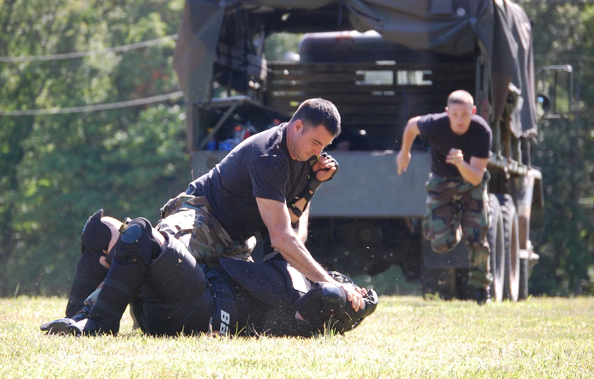 Students in the Air Force Phoenix Raven Training Course battle an "agressor" during an evaluation session for the students on a Fort Dix, N.J., range Aug. 20, 2008.  The Raven course, taught by the U.S. Air Force Expeditionary Center's 421st Combat Training Squadron, provides specialized training to security forces Airmen in areas such as aircraft security, self defense and verbal communications.  Upon graduation, the students receive their Raven number and are certified to fly and protect Air Force aircraft at austere airfields around the world.  (U.S. Air Force Photo/Tech. Sgt. Scott Mueller)