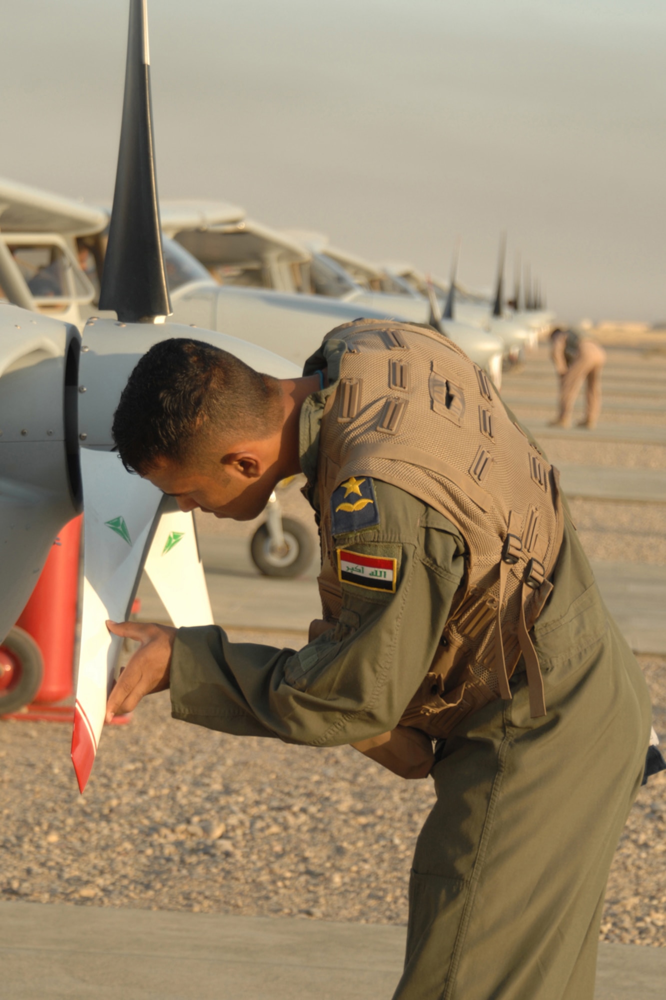 KIRKUK REGIONAL AIR BASE, Iraq -- An Iraqi air force student pilot checks the prop of a Cessna 172 Skyhawk before an early morning training flight here Sept. 1.  The pilot is part of the 52nd Expeditionary Flying Training Squadron's effort to help train the next generation of Iraqi pilots.  The newest class more than doubled the squadron's student population as they began the year-long program.  The new pilots underwent medical and physical tests during the application process and were also required to pass an English proficiency course. Upon graduation, the Iraqi pilots are assigned to units that either conduct an airlift mission with C-130 aircraft, or an intelligence, surveillance and reconnaissance mission with King Air 350, Cessna 208 and CH-2000 aircraft. (U.S. Air Force photo/Master Sgt. Andrew Leonhard)