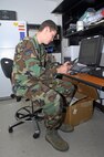 MINOT AIR FORCE BASE, N.D. -- Airman 1st Class Christopher Bell, 5th Communications Squadron ground radio technician, programs a land mobile radio with the proper frequency encryption here recently. Updating encrypted frequencies on LMRs is just one of many missions performed by the 5th CS ground radio shop. (U.S. Air Force photo by Airman 1st Class Benjamin Stratton)