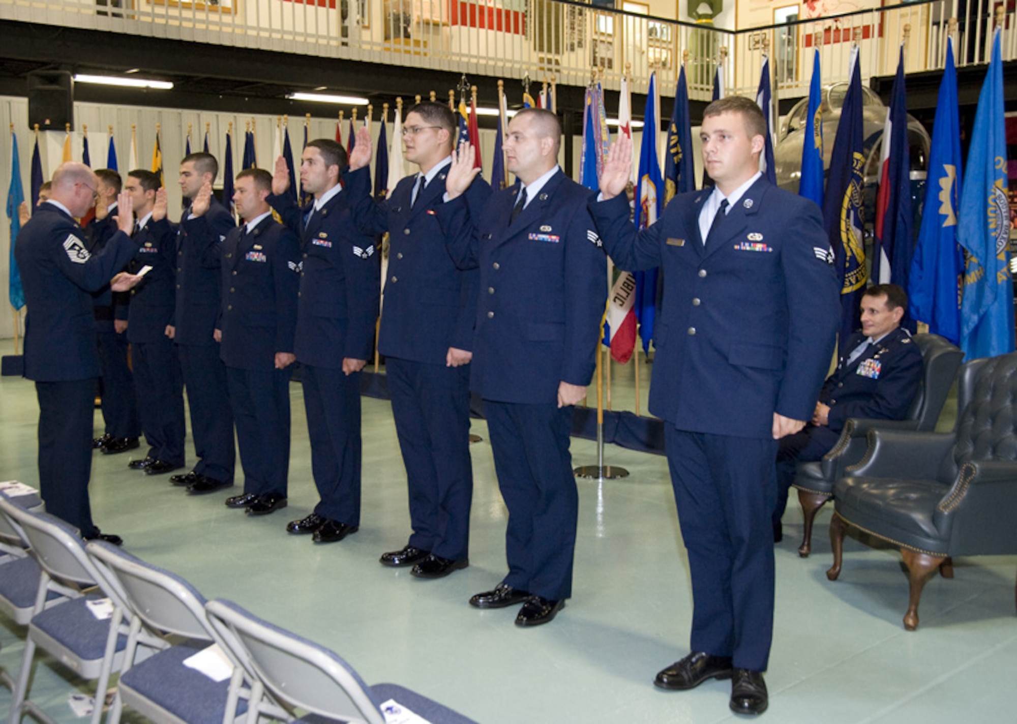 Nine newly selected NCOs are given the oath of enlistment by Chief Master Sgt. Terry West, 53d Wing command chief, during the 53d's NCO induction ceremony Aug. 28 at the Air Armament Museum.  The new NCOs are Matthew Benoit, Travis Hardie, Adam Ligon, Joseph Tossi, Robert McKettrick and Jason Randall (16th Electronic Warfare Squadron); Wesley Holifield and Gregory Mushel (53d Computer Systems Squadron); Matthew Knadler (68th EWS).  U.S. Air Force photo.

