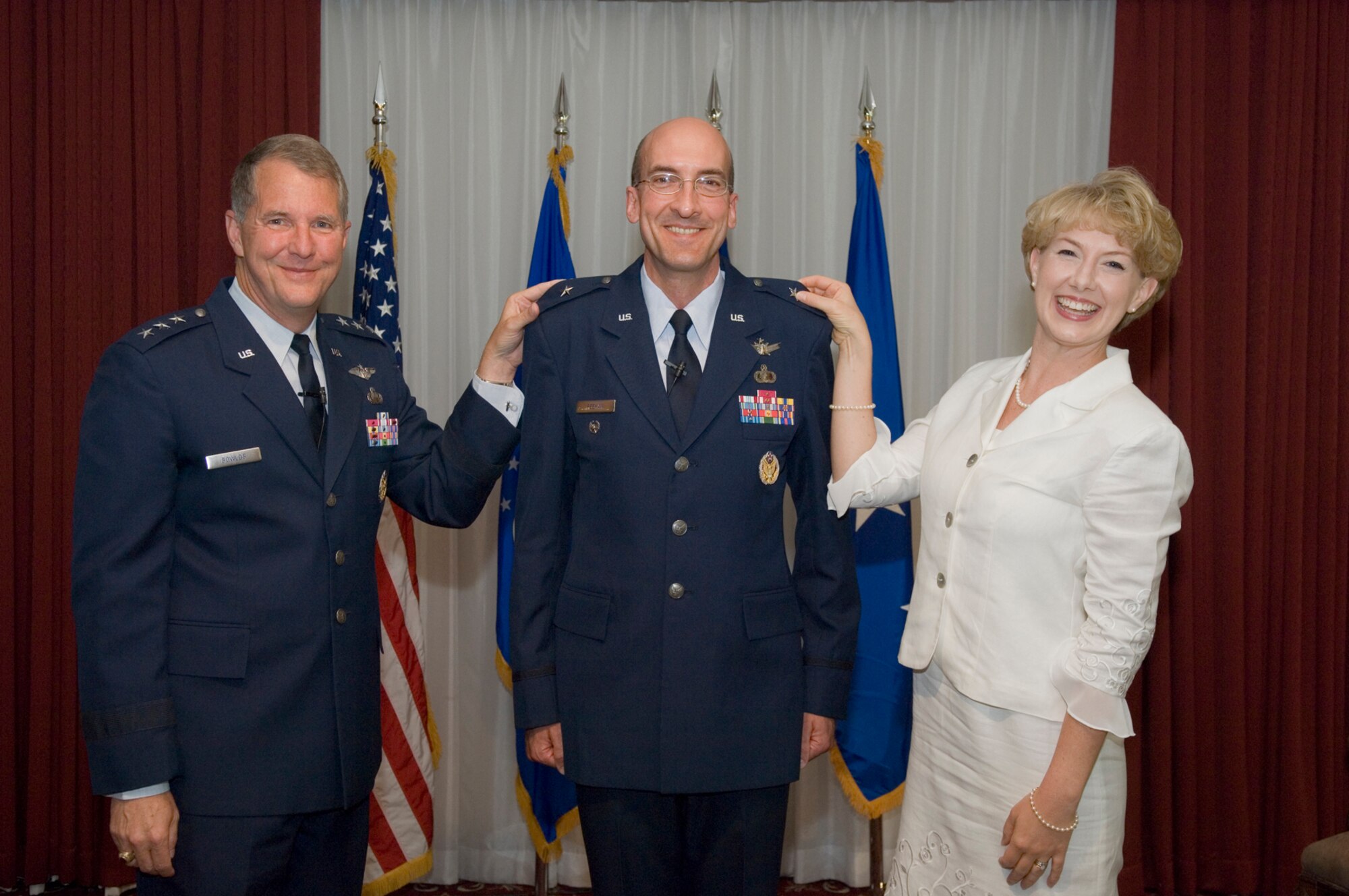 Electronic Systems Center Vice Commander Brig. Gen. Terry Feehan poses with his wife, Becky, and ESC Commander Lt. Gen. Ted Bowlds, after they pinned on his first star during a Sept. 2 ceremony at Hanscom’s Minuteman Club. 