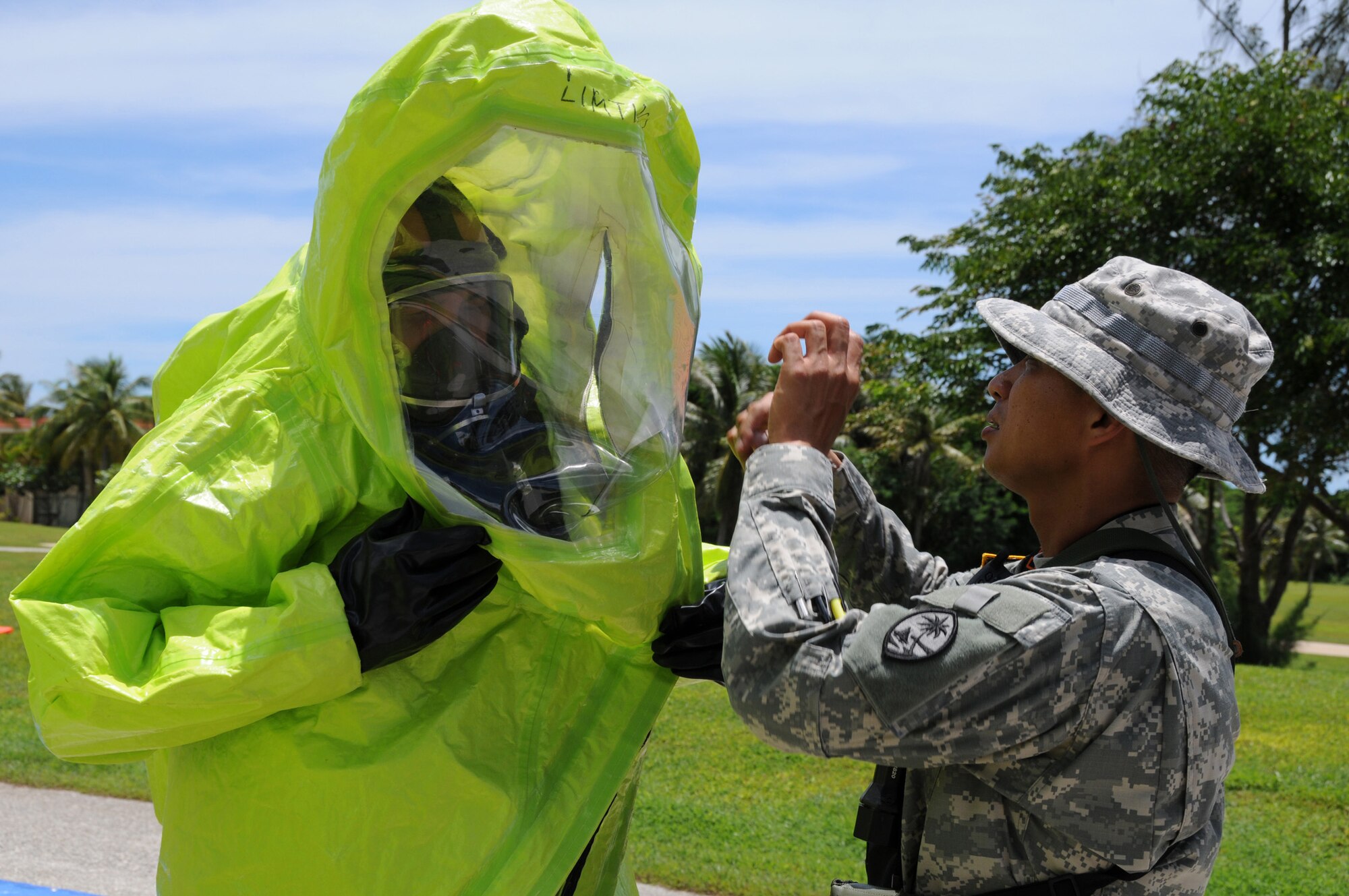 ANDERSEN AIR FORCE BASE, Guam - A member of Guam's National Guard Civil Support Team suits up to enter a contaminated house in Fleming Heights during a certification exercise here August 25. The house contained simulated weapons of mass destruction designed to trigger the detection equipment owned by the Guam National Guard CST. (U.S. Air Force photo by Staff Sgt. Jamie Lessard)