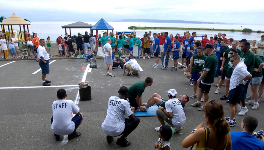 MISAWA AIR BASE, Japan -- The crowd watches as Airmen compete in a squadron survivor challenge during the Labor Day Beach Bash Aug. 29, 2008.  The competition consisted of sit-ups, push-ups and a relay with a weighted container.  (U.S. Air Force photo by Senior Airman Chad Strohmeyer)
