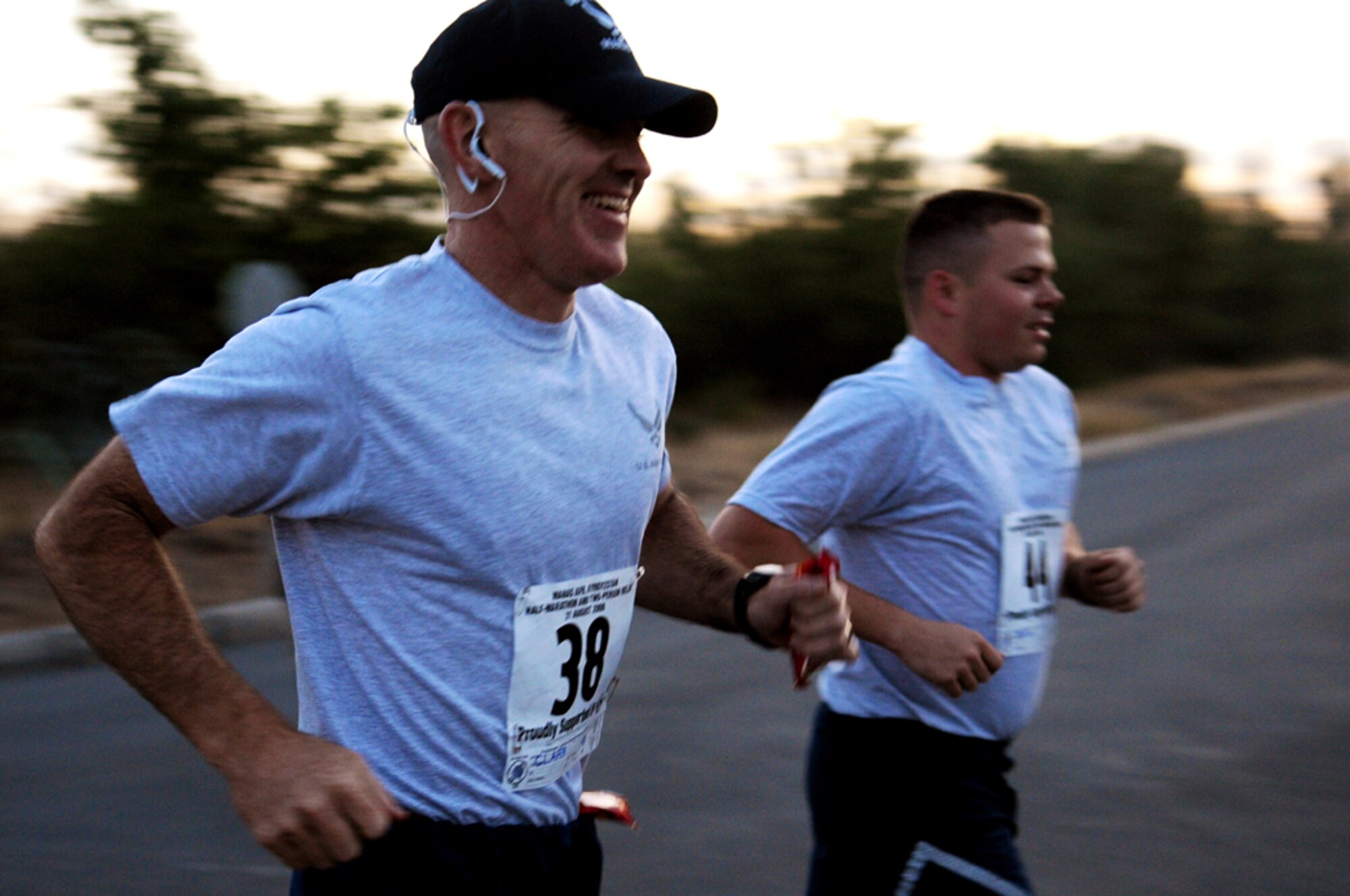 08/31/2008 - MANAS AIR BASE, KYRGYZ REPUBLIC -- Col. Murray Clark, 376th Expeditionary Operations Group commander, runs along side Senior Airman Raymond Bibb, 376th Expeditionary Logistics Readiness Squadron, during the half marathon here, Aug. 31. Col. Clark came in first place with a time of one hour, 26 minutes with Airman Bibb coming in second place only three minutes behind. (Air Force photo / Airman 1st Class Ruth Holcomb)