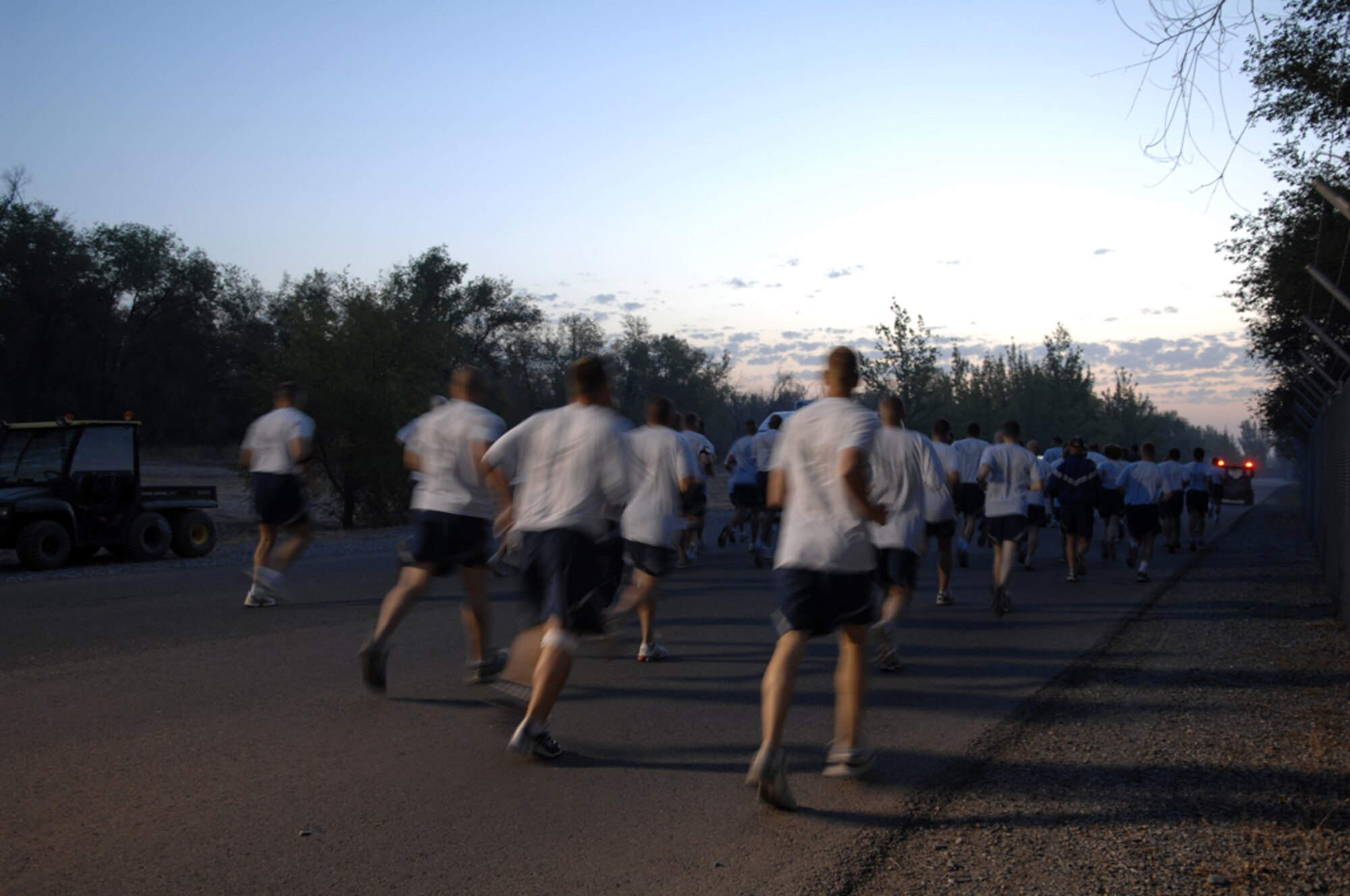 MANAS AIR BASE, KRYGYZ REPUBLIC -- Runners of the Manas AB half-marathon begin their long journey to the finish line 13.1 miles away as the sun rises over the base, Aug. 31. Over 100 "Liberando" Airmen challenged themselves mentally and physically to participated in and complete the half marathon. (Air Force photo / Tech. Sgt. Michael Voss)  