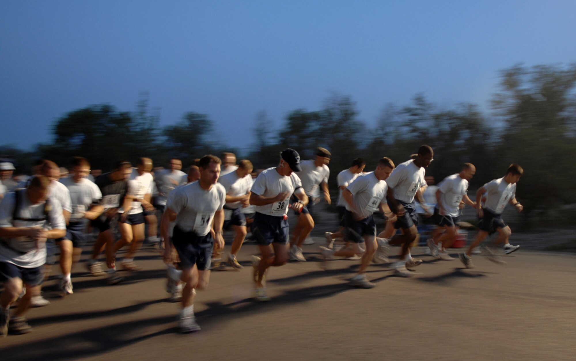 MANAS AIR BASE, KRYGYZ REPUBLIC -- Runners break into stride as the Manas AB half marathon kicks off at sunrise, Aug. 31. Over 100 "Liberando" Airmen challenged themselves mentally and physically to participate in and complee the 13.1 mile run across the base. (Air Force photo / Tech. Sgt. Michael Voss)  