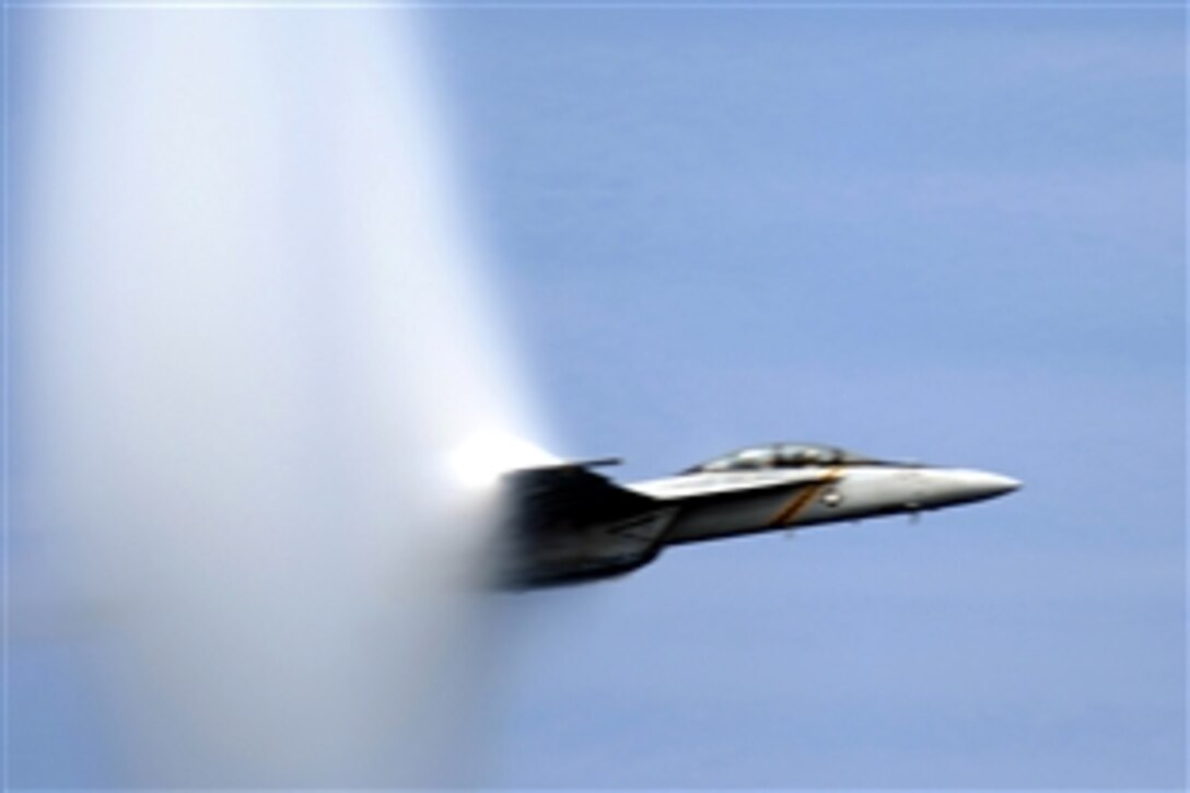An F/A-18E Super Hornet, reaches the speed of sound near the USS Dwight D. Eisenhower  during a Friends and Family Day Cruise off the coast of Virginia, Aug. 30, 2008. The 2008 Friends and Family Day Cruise enables guests to experience a day at sea with sailors assigned to the ship.