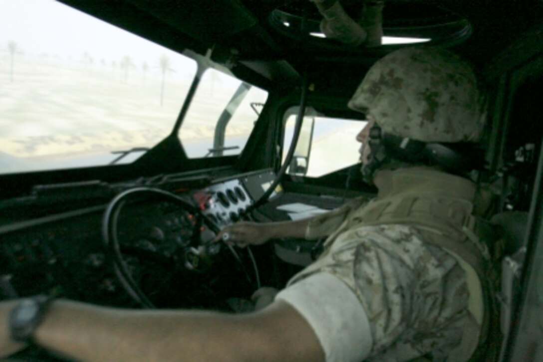 Cpl. William R. Ellington, armorer, MWSS-373, 3rd MAW, navigates his Humvee through rough terrain while engaging enemy units in the Combat Convoy Simulator.