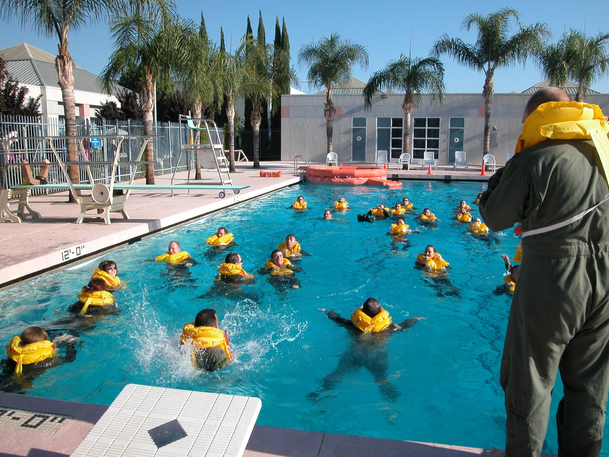Crewmembers from the 336 ARS and the 729 AS enter the water and prepare to swim toward a 20-man life raft for boarding. (U.S. Air Force photo by Staff Sgt. Joe Davidson, 452 AMW/PA)