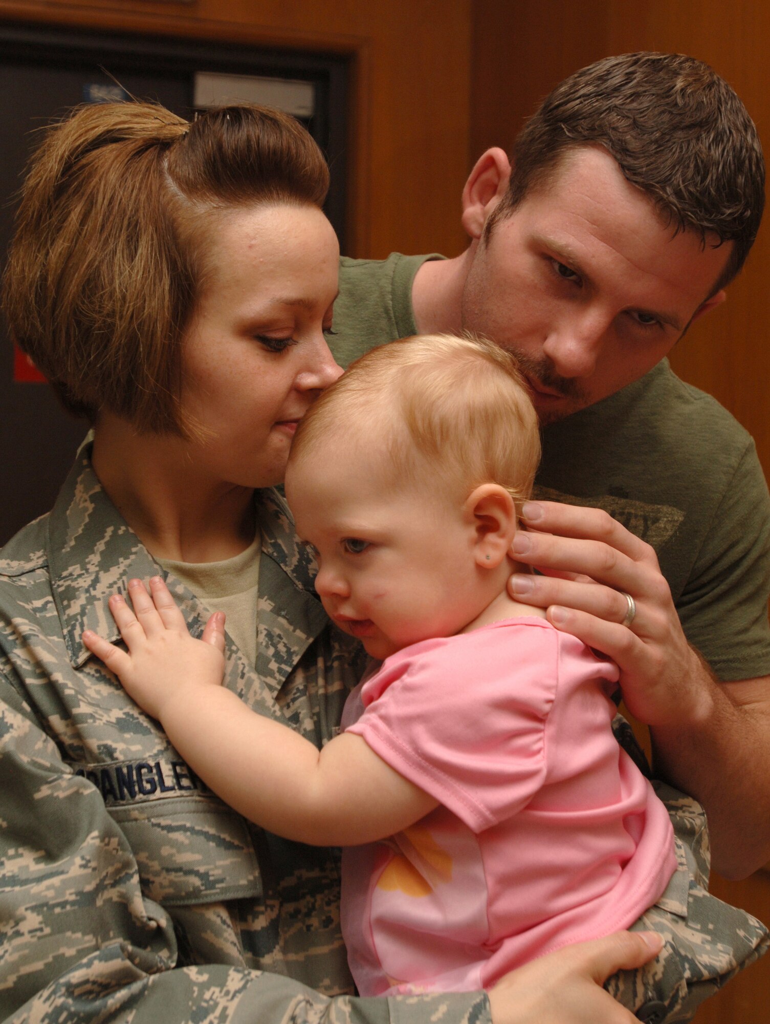 Senior Airman Erin Spangler, with the 59th Medical Wing's Post Anesthesia Care Unit at Wilford Hall Medical Center, Lackland Air Force Base, Texas, visits with her husband Ryan Spangler and their daughter Makenna, 14 months, as they say their 'goodbyes' Sept. 4 before Airman Spangler deploys for four months to Joint Base Balad, Iraq.  (U.S. Air Force photo/Senior Airman Josie Kemp) 