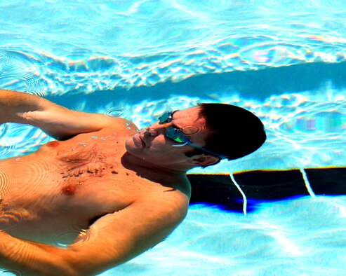 Maj. Kurt Kochendarfer, 301st Fighter Squadron pilot, glides along underwater before surfacing to do the backstroke as part of the 200-meter team medley in the Luke Intramural swim meet Aug. 22. (U.S. Air Force photo/Airman 1st Class C.J. Hatch)