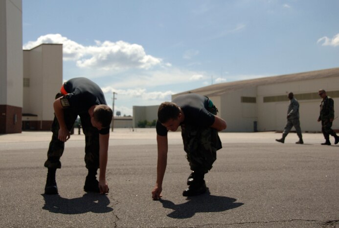 Airman 1st Class Ryan Luczkowiak and Airman 1st Class Troy White pick up trash found on the Charleston AFB flightline Sept. 4. The 437th Maintenance Squadron participated in a foreign object disposal walk after all aircraft evacuated the base in preparation for possible hurricane conditions. Airmen Luczkowiak and White are aerospace propulsion journeymen with 437 MXS. (U.S. Air Force photo/Airman 1st Class Cynthia Spalding) 
