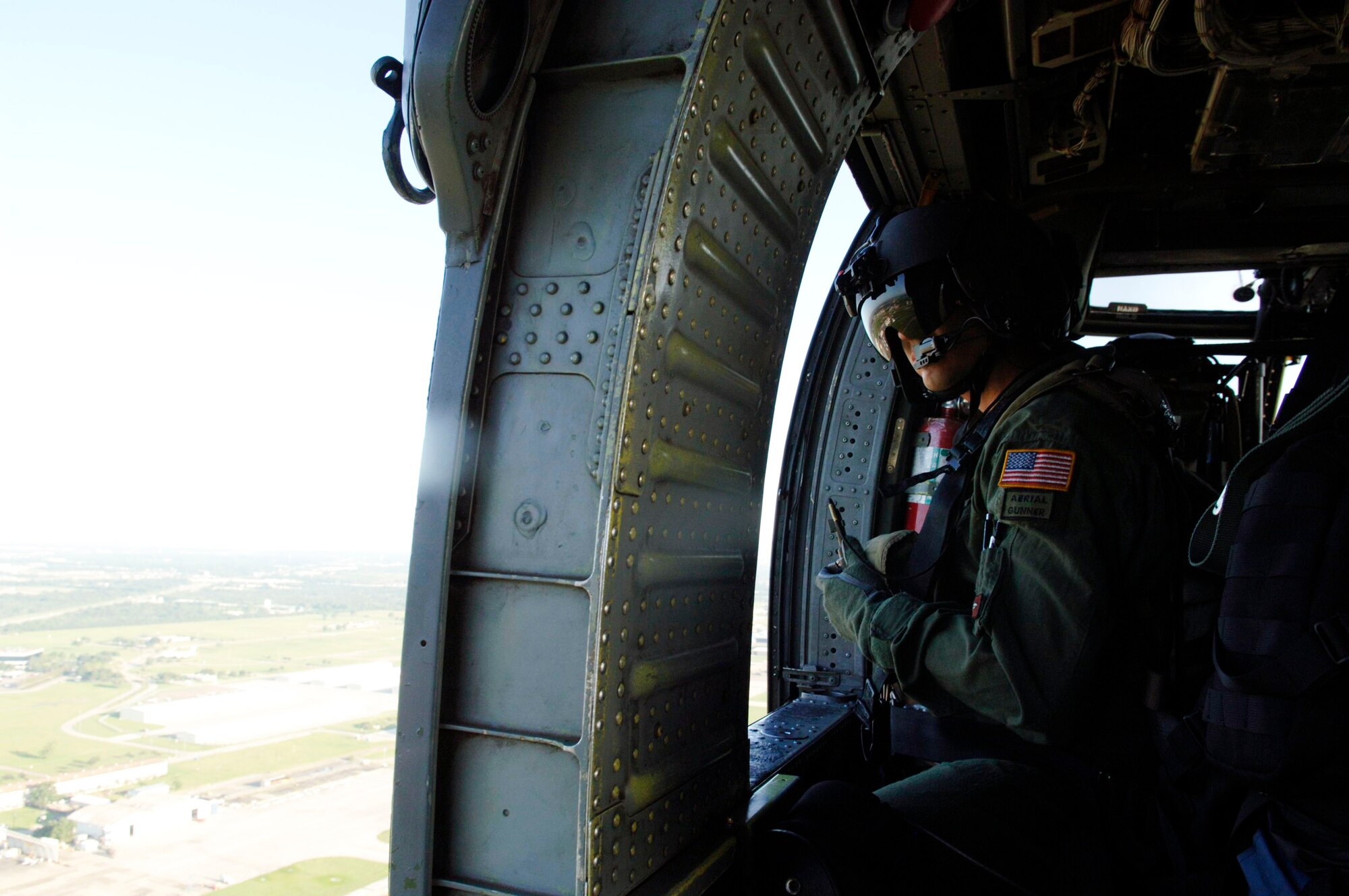 Staff Sgt. Andy Pena performs in-flight calibrations on a HH-60 Pave Hawk while flying Sept. 3 over Ellington Field, Texas. He and members of the 55th Rescue Squadron deployed from Davis-Mothan Air Force Base, Ariz., to Ellington Field in response to Hurricane Gustav with less than 24 hours after notification. Sergeant Pena is an aerial gunner. (U.S. Air Force photo/Master Sgt. Ben Gonzales) 

