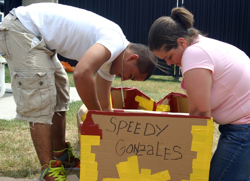 DOVER AIR FORCE BASE, Del. –  Airman Ryan Otero and Tech. Sgt. Charity Harmon, 436th Medical Group “A” Team members, build their boat “Speedy Gonzales,” for the Build-a-Boat Contest held at the Oasis Pool Aug. 29. Team Dover members built boats out of cardboard and duct tape. (U.S. Air Force photo/Theresa Krause)