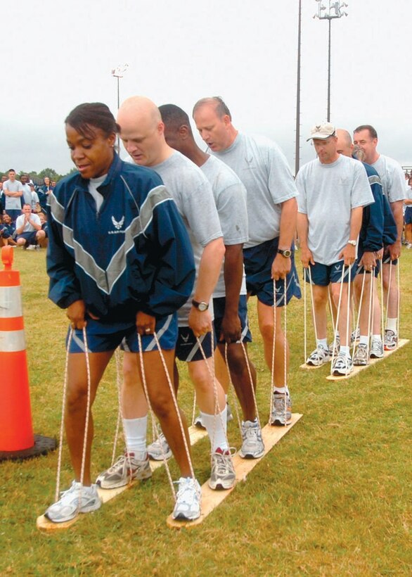 Chief Master Sergeants lead the way to victory over the trailing medical Wing leadership during a slueshing competition. The competition challenged  them to walk forward in unison around an obstacle in a race to the finish line Aug. 29. Approximately 700 members from the 79th Medical Wing participated in the day-long athletic event, which consisted of a two-mile walk/run,  the push-up and sit-up contest, softball, basketball, volleyball, tug-of-war and slueshing competitions. The purpose of the event was to foster Esprit de corps among fellow Airmen within the 79th and 579th Medical Groups. (U.S. Air Force photo by Bobby Jones)