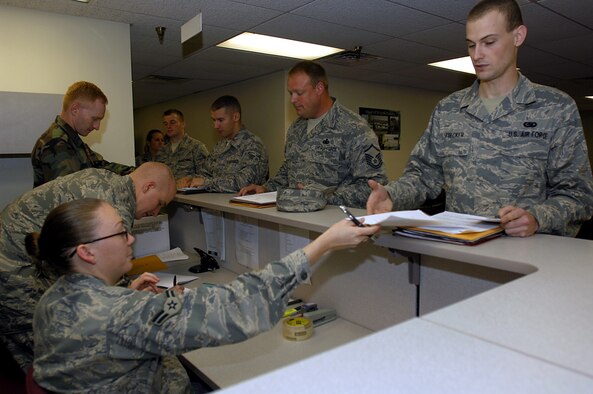 MINOT AIR FORCE BASE, N.D. — 5th Bomb Wing and 91st Missile Wing Airmen go through the Installation Personnel Readiness Element line here Aug. 28.  During the IPRE process, Airmen gather essential paperwork to prepare for their future deployment. (U.S. Air Force photo by Airman 1st Class Jesse Lopez)
