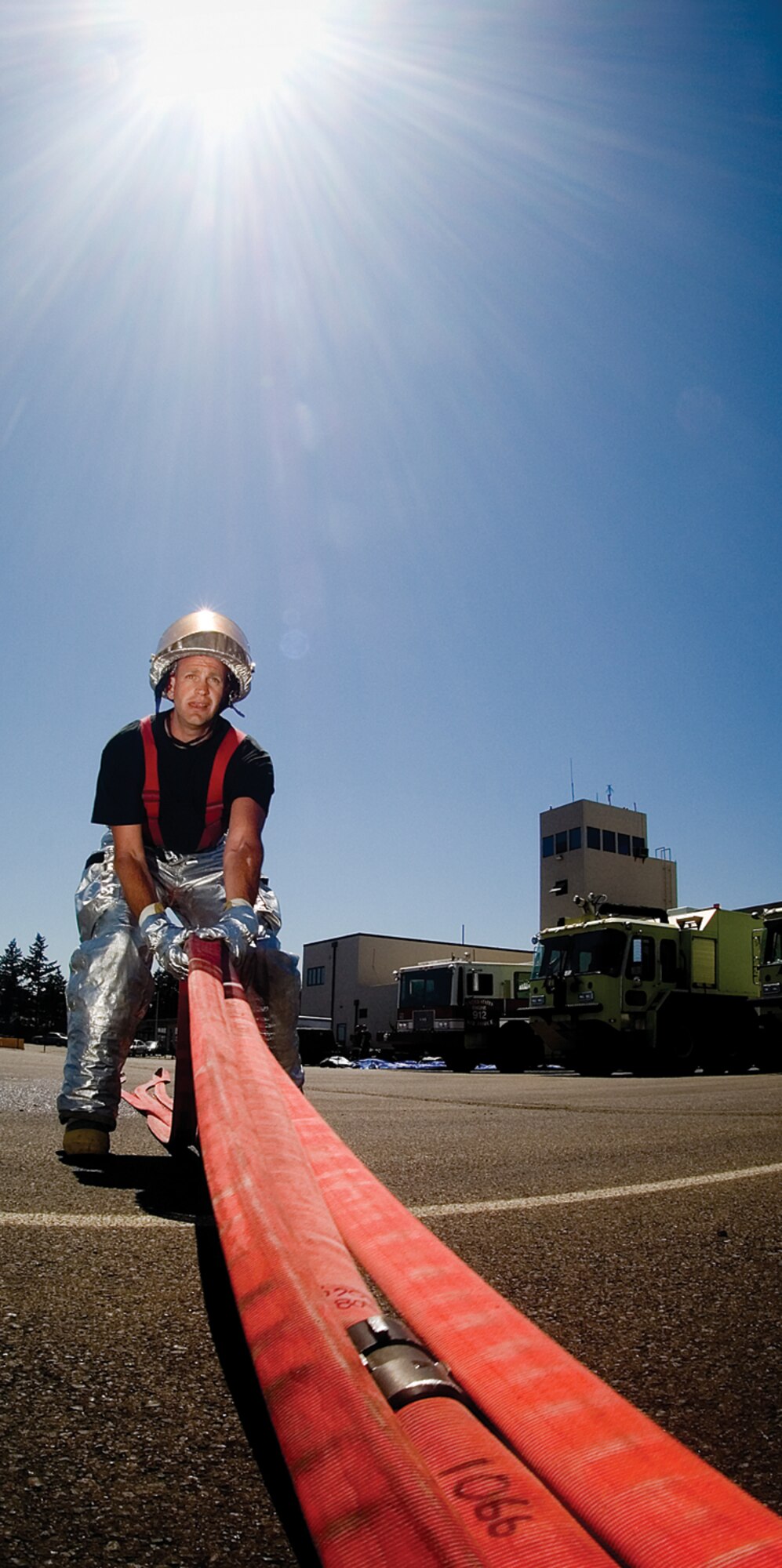 Master Sgt. Mathew Camier, 446th Civil Engineer Squadron firefighter, McChord Air Force Base, Wash., organizes a hose in three layers to reload onto a fire engine. Sergeant Camier is one of 2,400 Citizen Airmen in the Air Force Reserve's 446th Airlift Wing serving our nation.(U.S. Air Force photo/Abner Guzman)