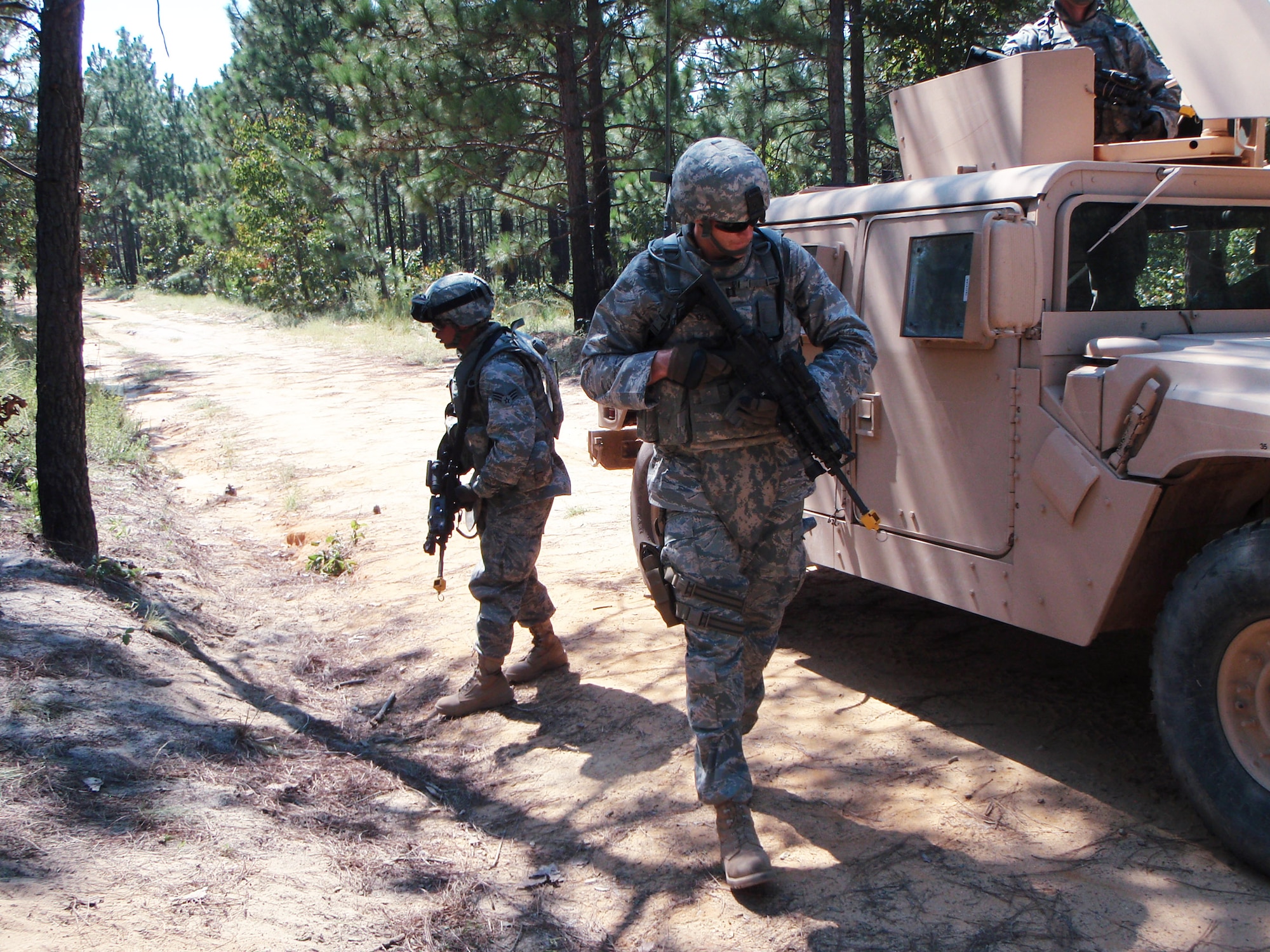 Senior Airman Robert Cabato (left) and Capt. Nathan Olsen conduct five and 25 meter checks for improvised explosive devices during recent convoy training here. Both Airmen are a part of the Zabul Reconstruction Team, and are training for an upcoming deployment. Captain Olsen is deployed from the 375th Civil Engineer Sqaurdon at Scott Air Force Base, Ill., and Airman Cabato is deployed from the 18th Operations Group at Kadena Air Base, Japan. (U.S. Air Force photo)     