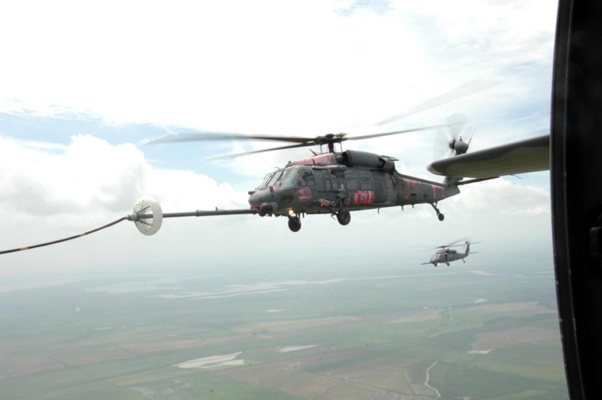 Two HH-60G Pave Hawks perform an aerial refueling mission with an MC-130P Combat Shadow over Louisiana Sept. 2. The aircraft and crew are from the 129th Rescue Wing based out of Moffett Federal Airfield, Calif. More than 80 Airmen from the 129th RQW deployed to Ellington Field, Texas, as part of Joint Task Force 129, which supported Hurricane Gustav rescue operations. Air National Guardsmen from the 106th Rescue Wing, Gabreski Airport, N.Y., and 176th Wing, Kulis Air National Guard Base, Alaska, were also part of the rescue task force. (U.S. Air Force photo by Tech. Sgt. Ray Aquino)
