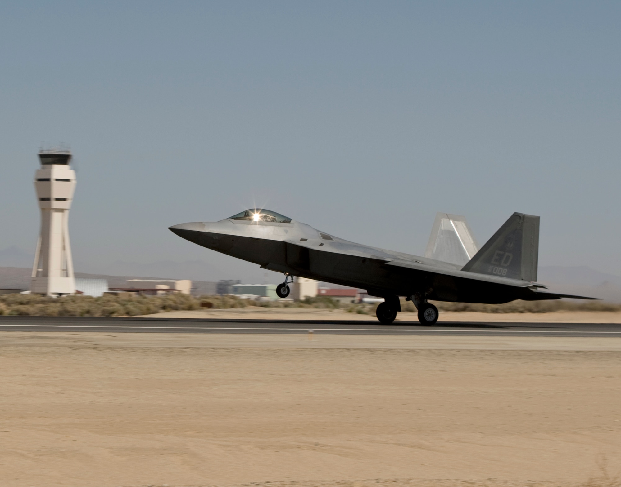 An F-22 Raptor takes off from Edwards Air Force Base, Calif., Aug. 28 to take part in an aerial refueling test using an alternative jet engine fuel -- a first for an Air Force aircraft. The fuel is a 50/50 mix of JP-8 jet fuel and a natural gas-based fuel.  (Lockheed Martin photo)