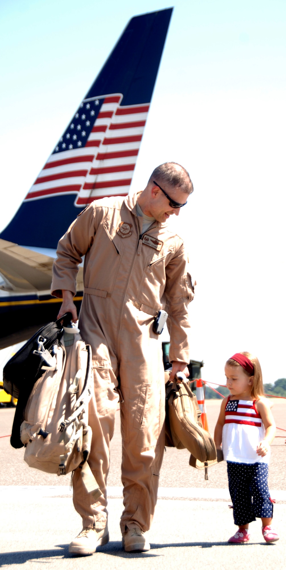 Lt. Col. Norman "Buddy" Czubaj walks with his daughter, Arianna, on the Charleston AFB flightline after arriving home Sept. 3. The 14th Airlift Squadron returned from a four-month deployment to Southwest Asia. Colonel Czubaj is  the 14 AS commander.  (U.S. Air Force Photo/Airman 1st Class Cynthia Spalding)