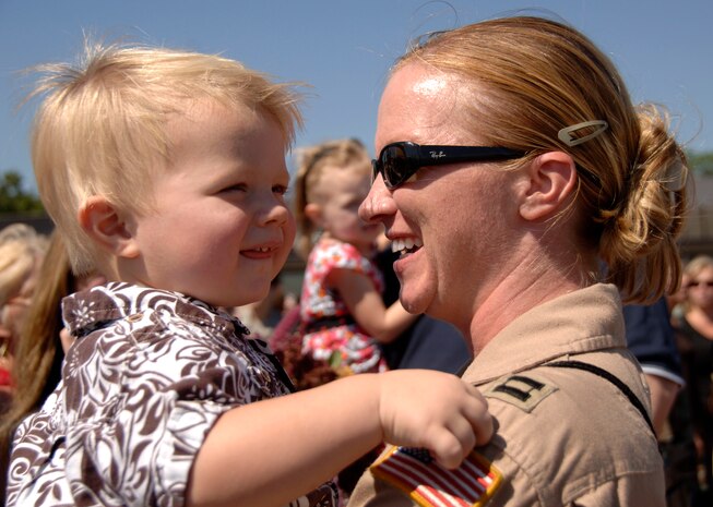 Capt. Kay Hasson holds her godson, Sammy, on the Charleston AFB flightline after arriving home Sept. 3. The 14th Airlift Squadron returned from a four-month deployment to Southwest Asia. Captain Hasson is with the 14 AS.  (U.S. Air Force photo/Airman 1st Class Cynthia Spalding)