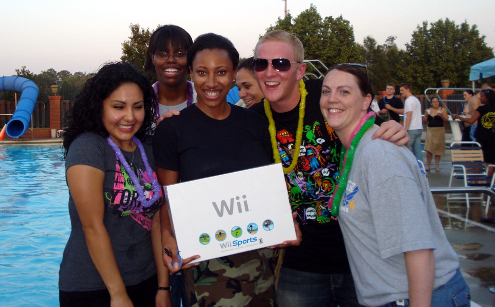 Airman 1st Class Ruby Barrera, 50th Flying Training Squadron, Staff Sgt. Anedra Davis, 14th Communications Squadron, Airman 1st Class Persian Jones, Operational Support Squadron, Airman 1st Class Brianna Bergstrand, 14th CS, Airman Josh Harbin, 14th Flying Training Wing, and Staff Sgt. Jamie Somers, 14th Force Support Squadron, celebrate Airman Jones’ win of a Nintendo Wii at the Dorm Dinner held at the Base Pool Aug. 28. BLAZE 56 sponsored the event. The next Dorm Dinner is scheduled for Oct. 16. (U.S. Air Force photo by Staff Sgt. Cliff Somers)