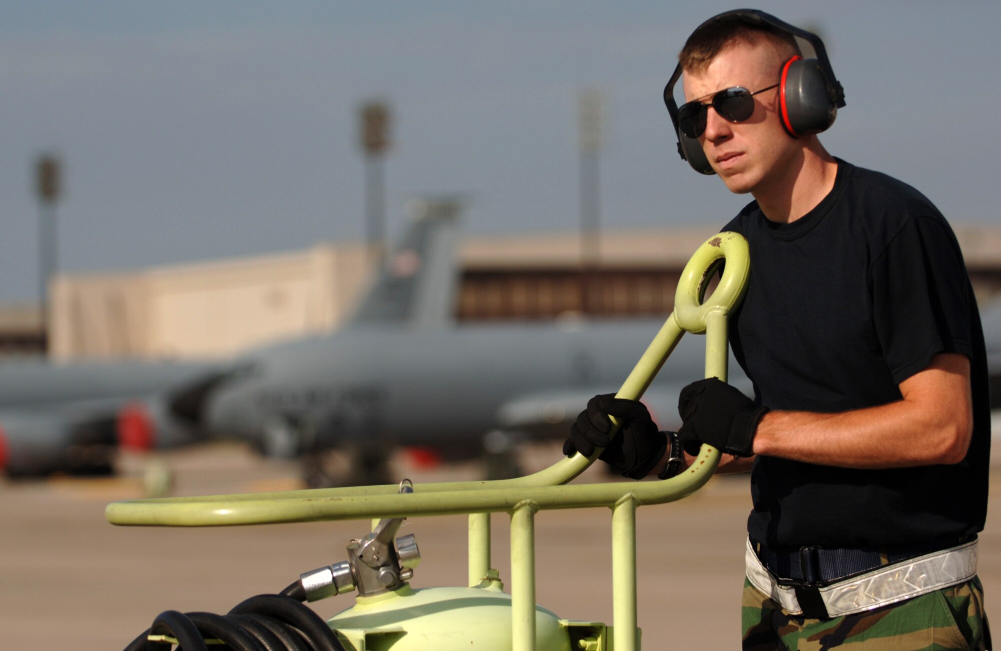 Staff Sgt. Jeremiah Babcock mans a fire extinguisher while a KC-135 Stratotanker is refueled on the flightline of McConnell Air Force Base, Kan., on Sept. 2.  Sergeant Babcock is a traditional Reservist assigned to the Communications and Navigation section of the 931st Aircraft Maintenance Squadron, but he often performs fireguard and other crew chief duties to help fill in for deployed active-duty maintainers. (U.S. Air Force photo/Tech. Sgt. Jason Schaap)    