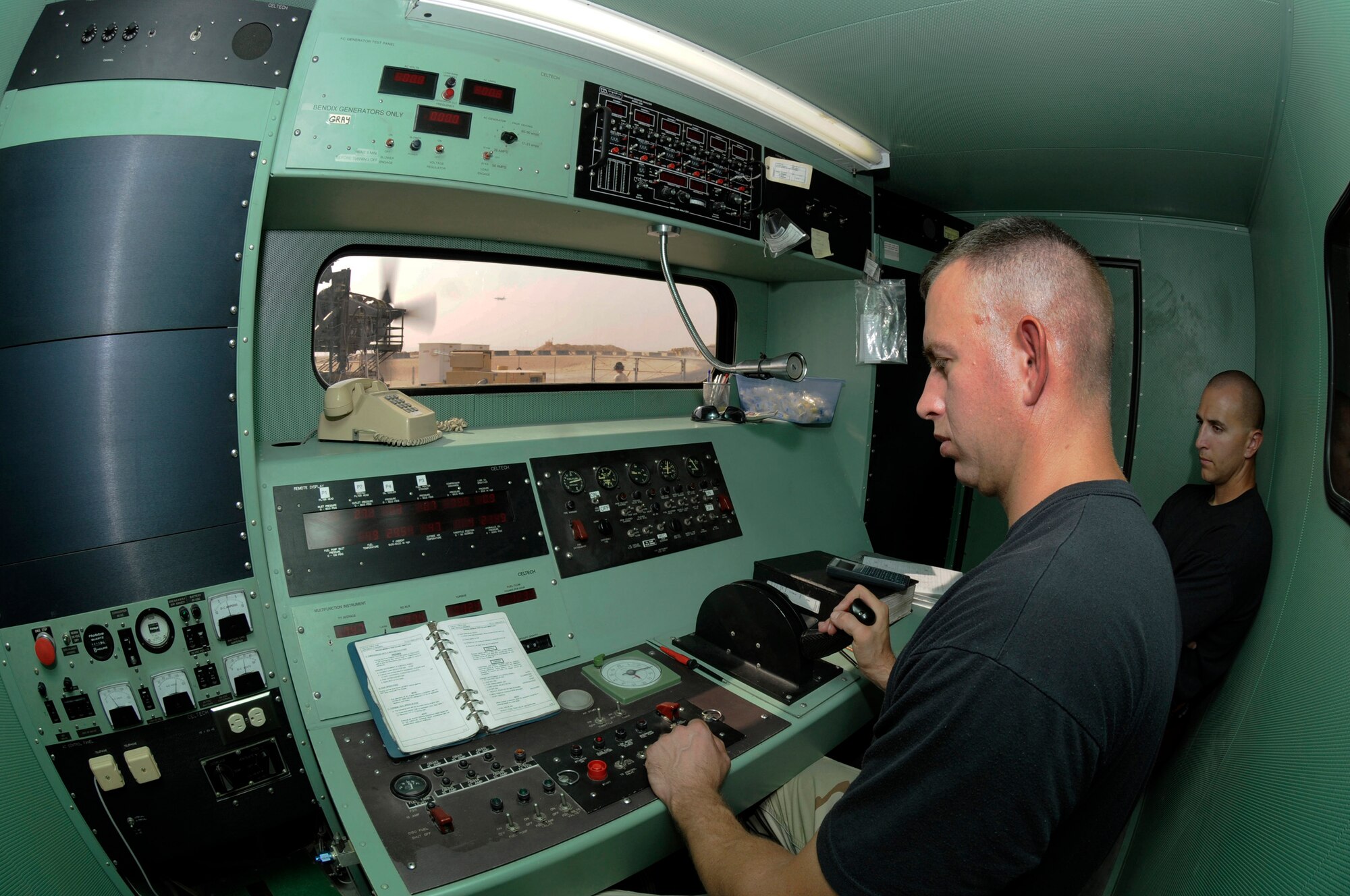 Tech. Sgt. Gregory Mathes, 379th Expeditionary Maintenance Squadron, works the throttle in the control booth during an engine operations test as Senior Airman Beau Columbus, 379 EMXS, watches and records all results Sept. 3, 2008, at an undisclosed air base in Southwest Asia.  The C-130 Hercules primarily performs the tactical portion of the airlift mission. The aircraft is capable of operating from rough, dirt strips and is the prime transport for air dropping troops and equipment into hostile areas.  Sergeant Mathes, a native of Greenville, Tenn., is deployed from Ramstein Air Force Base, Germany and Airman Columbus, originally from Buffalo, N.Y., is deployed from Yokota Air Base, Japan.  Both are supporting Operations Iraqi and Enduring Freedom and Joint Task Force-Horn of Africa. (U. S. Air Force photo by Tech. Sgt. Michael Boquette/Released)