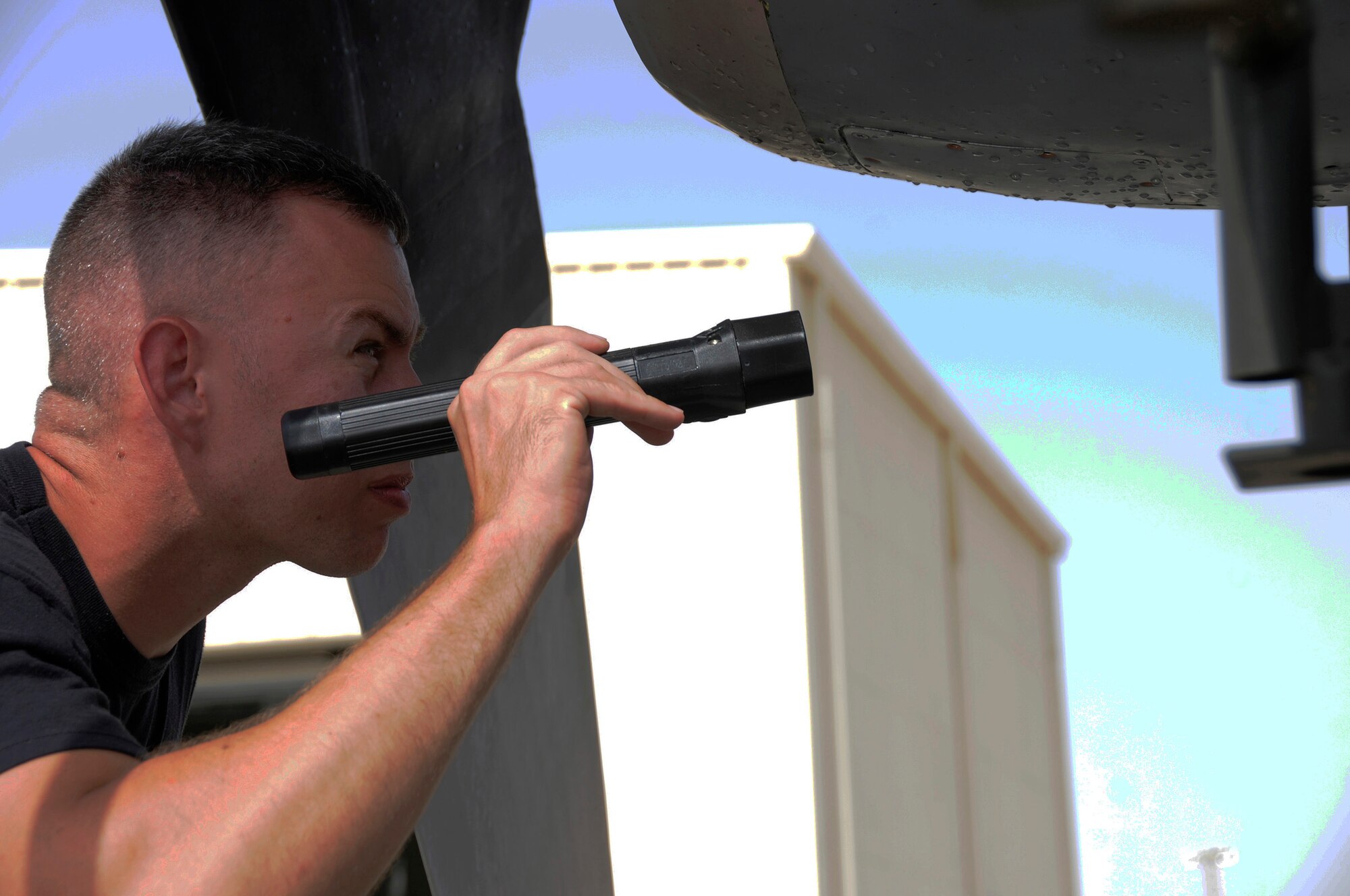 Tech. Sgt. Gregory Mathes, 379th Expeditionary Maintenance Squadron, checks the intakes for foreign object damage to compressor blades and loose rivets prior to an engine operations test Sept. 3, 2008, at an undisclosed air base in Southwest Asia.  Checking for loose fan blades is one of the steps to get this C-130 Hercules engine back in operation.  The C-130 Hercules primarily performs the tactical portion of the airlift mission. The aircraft is capable of operating from rough, dirt strips and is the prime transport for air dropping troops and equipment into hostile areas.  Sergeant Mathes, a native of Greeneville, Tenn., is deployed from Ramstein Air Base, Germany, supporting Operations Iraqi and Enduring Freedom and Joint Task Force-Horn of Africa. (U.S. Air Force photo by Tech. Sgt. Michael Boquette/Released)