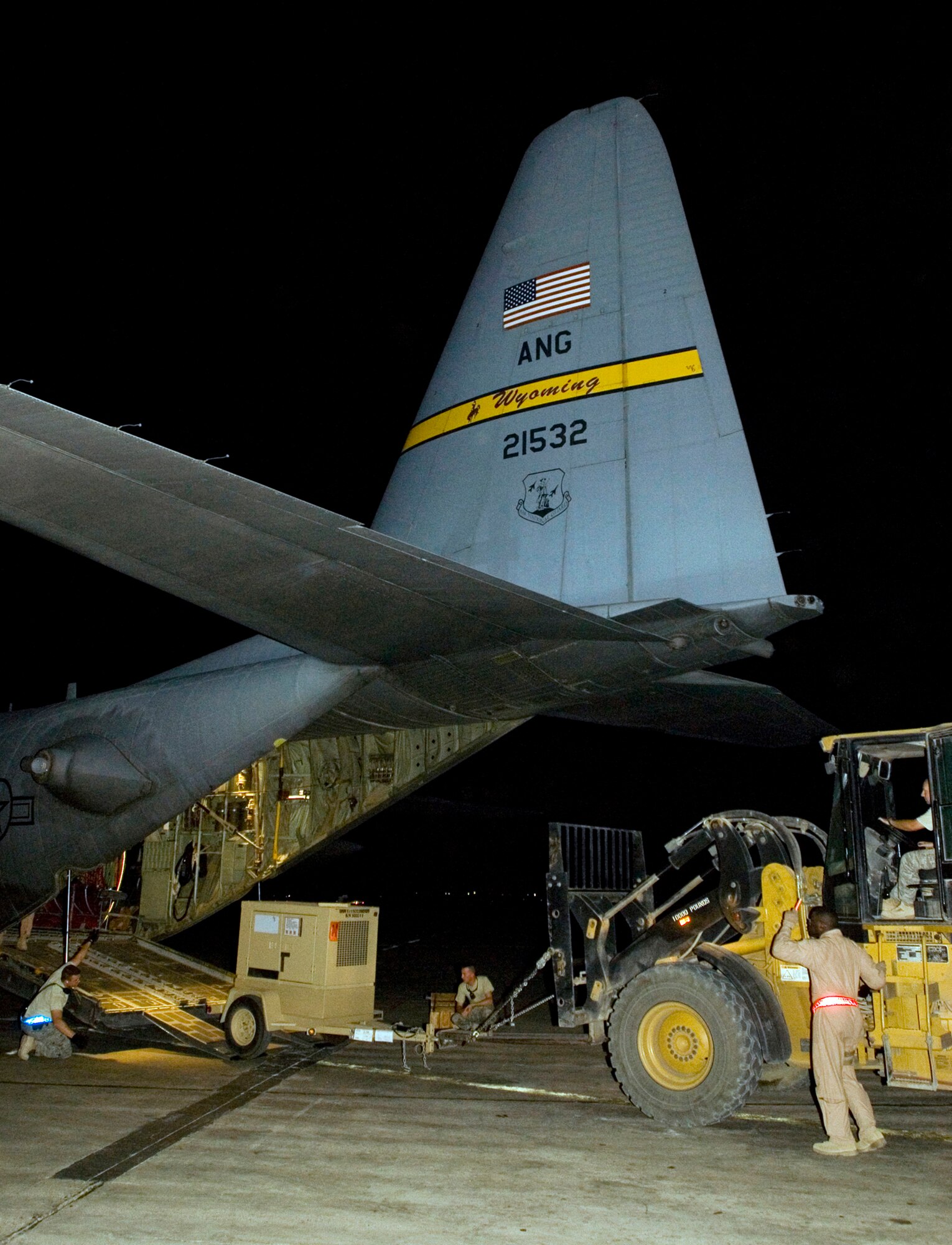 BAGHDAD INTERNATIONAL AIRPORT, Iraq -- Airmen with the 777th Expeditionary Airlift Squadron load portable generators aboard a C-130 Hercules here in the early hours of Sept. 3. The aircrew completed the squadron's 25,000th combat sortie, flying approximately 25 passengers and 64,000 pounds of equipment between Baghdad International Airport and Al-Asad Air Base. The crew is deployed to Joint Base Balad from Little Rock Air Force Base, Ark.; the aircraft is deployed from the Wyoming Air National Guard's 153rd Airlift Wing. (U.S. Air Force photo/Tech Sgt. Erik Gudmundson)