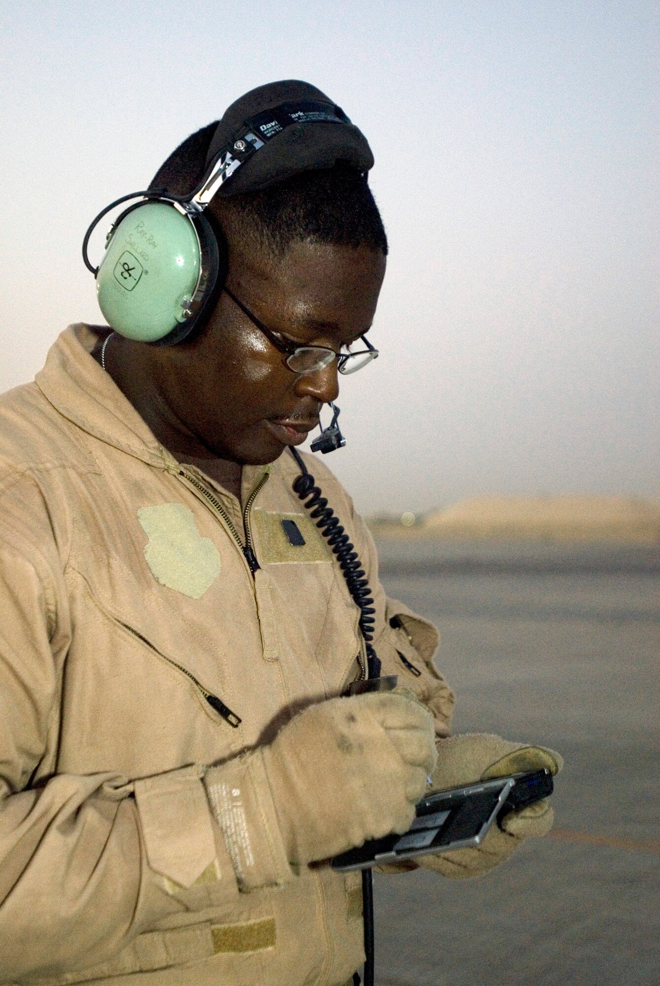 JOINT BASE BALAD, Iraq -- Tech. Sgt. Ray Sallard, a loadmaster with the 777th Expeditionary Airlift Squadron here, records data in a personal data assistant on the flightline in preparation for an airlift mission Sept. 2. Sallard was a member of the 777th EAS aircrew that completed the squadron's 25,000th combat sortie. He is deployed from Little Rock Air Force Base, Ark. (U.S. Air Force photo/Tech Sgt. Erik Gudmundson)