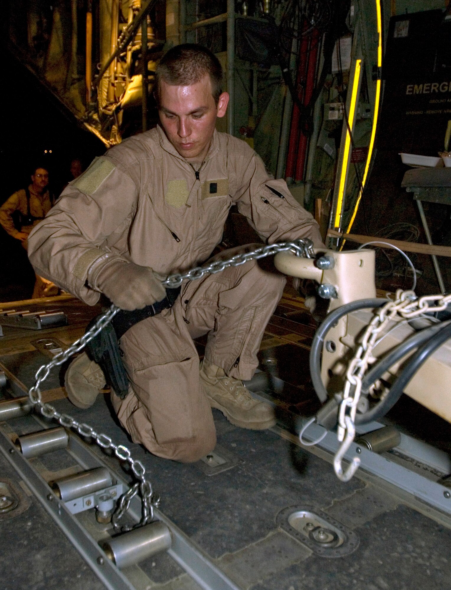 BAGHDAD INTERNATIONAL AIRPORT, Iraq -- Airman 1st Class Delmar Karnes, a loadmaster with the 777th Expeditionary Airlift Squadron, secures the tow bar of a portable generator in the cargo hold of a C-130 Hercules Sept. 3. Karnes, who is deployed from Little Rock Air Force Base, Ark., was part of the aircrew that flew the 777th EAS' 25,000th combat sortie since beginning operations at Joint Base Balad in February 2006. (U.S. Air Force photo/Tech Sgt. Erik Gudmundson)