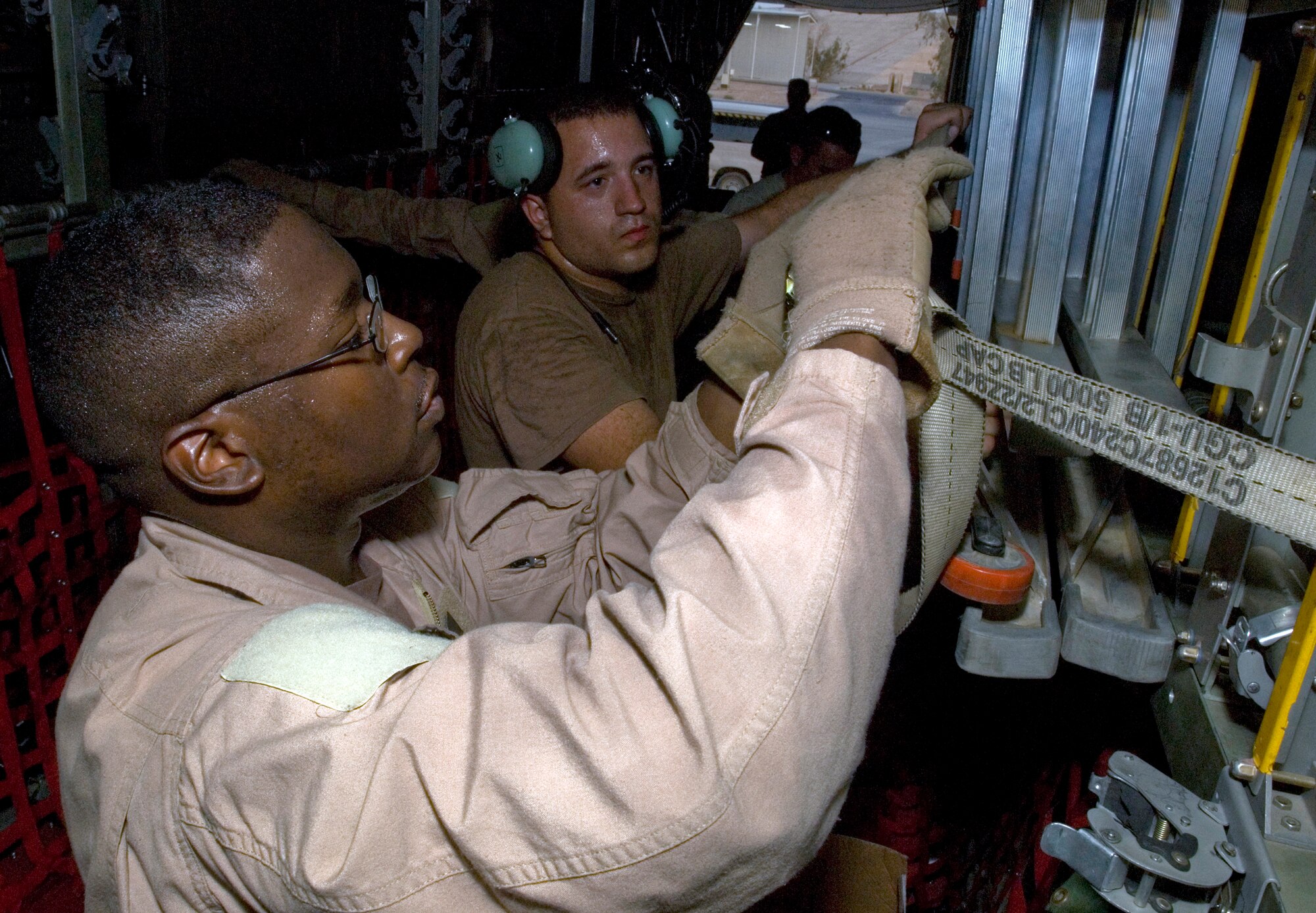 JOINT BASE BALAD, Iraq -- Tech. Sgt. Ray Sallard and Airman 1st Class Dillon Coons, loadmasters with the 777th Expeditionary Airlift Squadron here, secures a ladder in the cargo hold of a C-130 Hercules here just before takeoff Sept. 2. Sallard was a member of the 777th EAS aircrew that flew the squadron's 25,000th combat sortie since February 2006. He is deployed from Little Rock Air Force Base, Ark. (U.S. Air Force photo/Tech Sgt. Erik Gudmundson)
