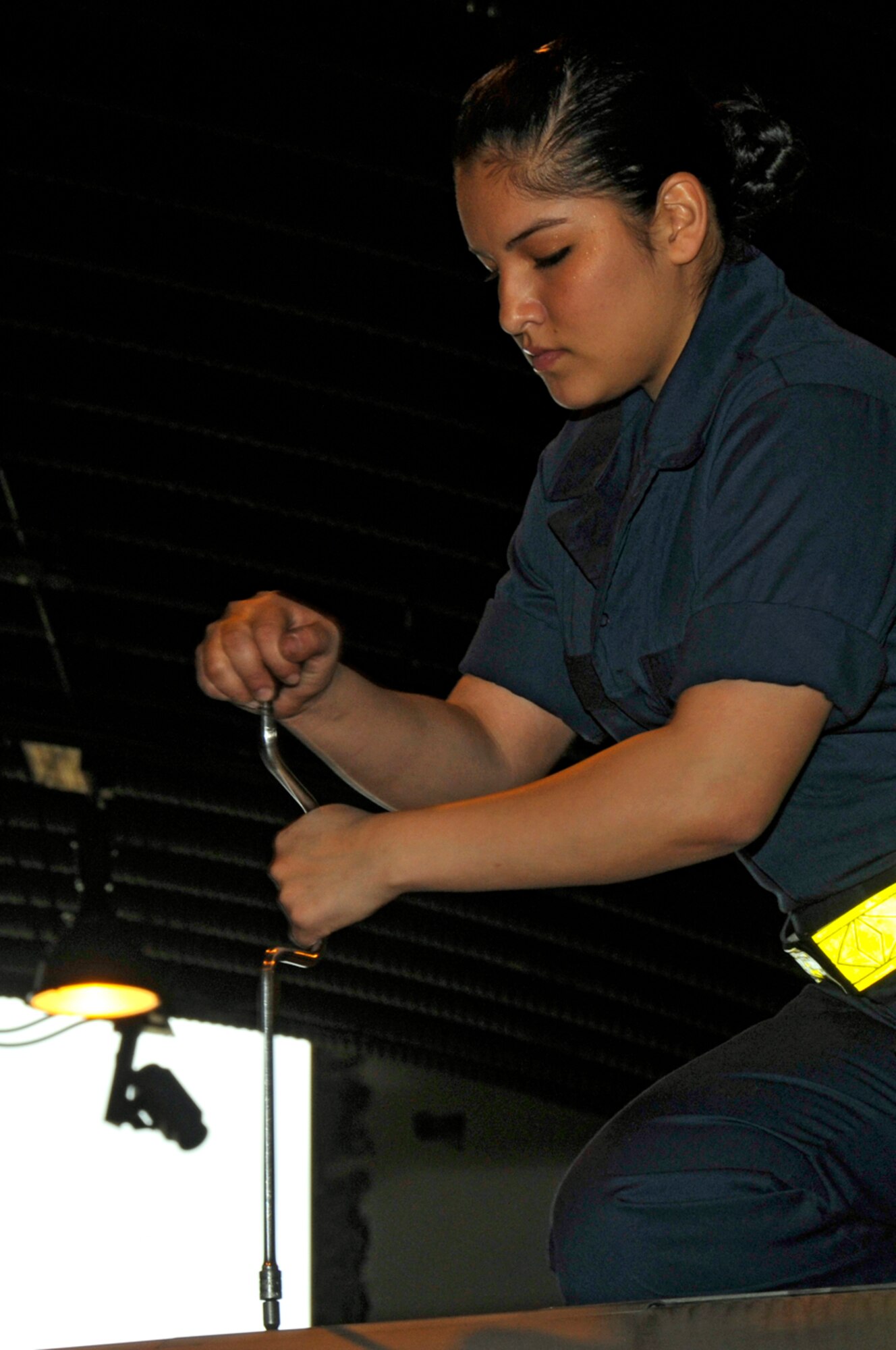 Airman 1st Class Guadalupe Morrell, 48th Equipment Maintanence Squadron F-15 phase inspection crew chief, removes panels from the right wing of an F-15 Eagle Aug. 29 at RAF Lakenheath, England. During phase inspection, Airmen inspect the overall structural integrity, flight avionics and mechinical systems of the aircraft. (U.S. Air Force photo by Airman 1st Class Perry Aston)