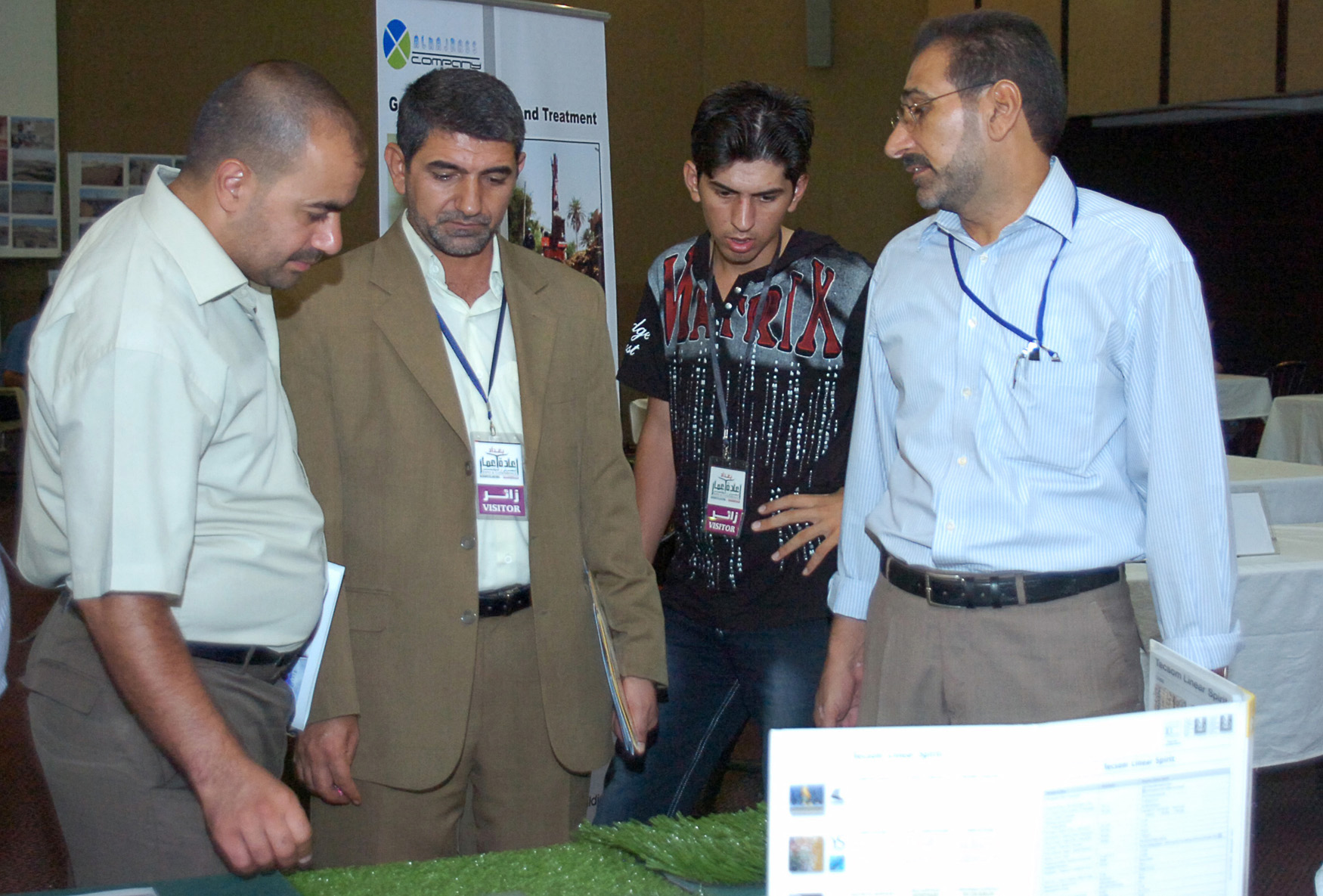 An Iraqi businessman shows Turkish artificial grass, which is one of