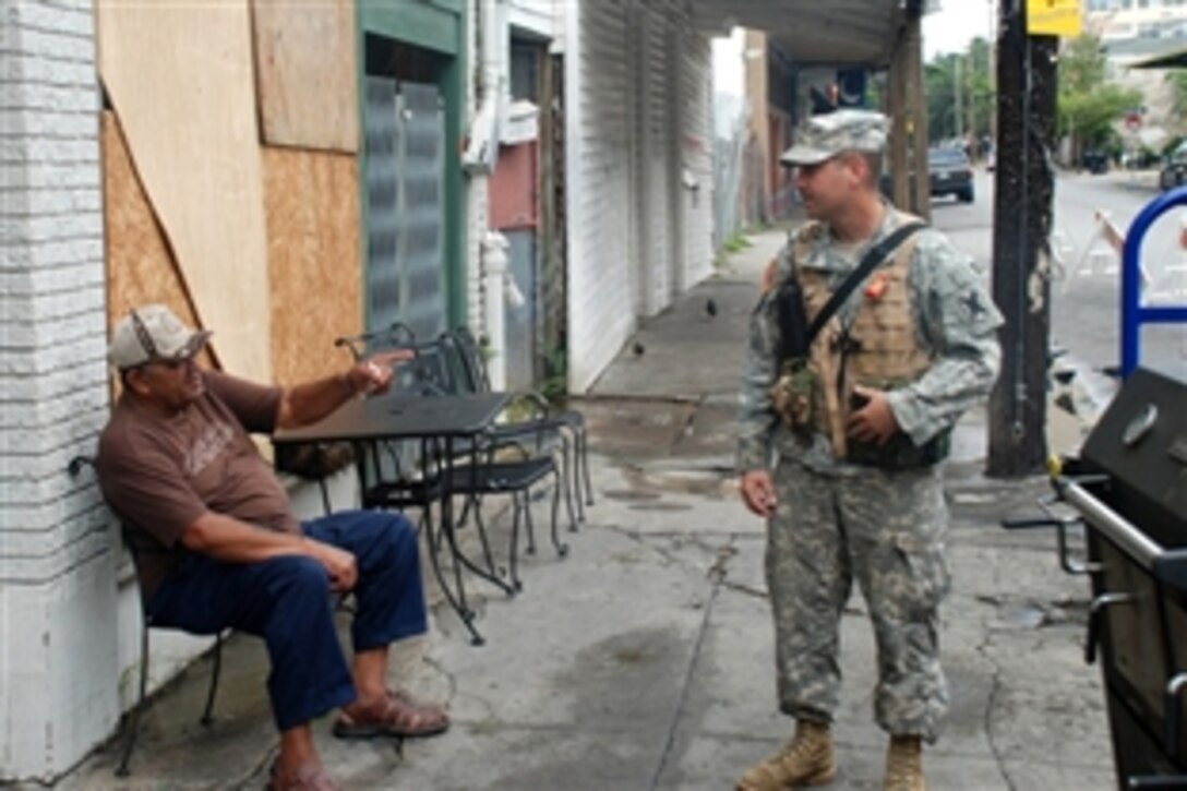 A member of the Louisiana National Guard's 256th Brigade Combat Team talks with a New Orleans resident after Hurricane Gustav passed through the city, Sept. 2, 2008. The 256th is assigned to assist the New Orleans Police Department and other law enforcement agencies with providing security throughout the city of New Orleans. 

