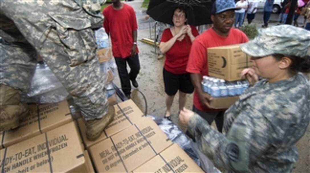 U.S. Army Spc. Jacquelyn Smith hands out bottles of water and boxes of meals, ready-to-eat to citizens affected by Hurricane Gustav in Baton Rouge, La., on Sept. 3, 2008.  Smith is assigned to the 1084th Transportation Company, Louisiana Army National Guard.  