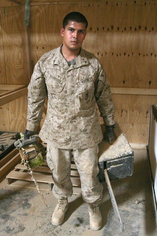 Lance Cpl. Jovan Rodriguez, a warehouse clerk with Task Force 2nd Battalion, 2nd Marines, Regimental Combat Team 5, organizes the supply warehouse at Camp Al Qa'im, Iraq, Sept. 10. He spent several days at Al Asad Air Base, Iraq, waiting to join his wife through a video teleconferencing for the birth of their first child.