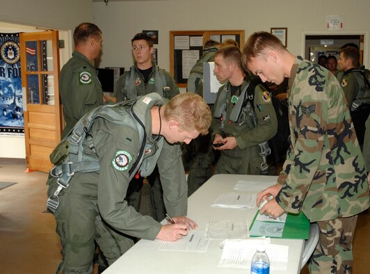 Strike Eagle aircrews undergo maintenance debrief at the Hurricane Evacuation Reception Center at Wright-Patterson Air Force Base, Ohio on Sept. 4.  About 250 aircrew, maintenance and security personnel and 75 F-15E aircraft deployed to Wright-Patterson from the 4th Fighter Wing, Seymour Johnson Air Force Base, N.C. to seek safe haven from Tropical Storm Hanna. (U.S. Air Force photo/Al Bright) 