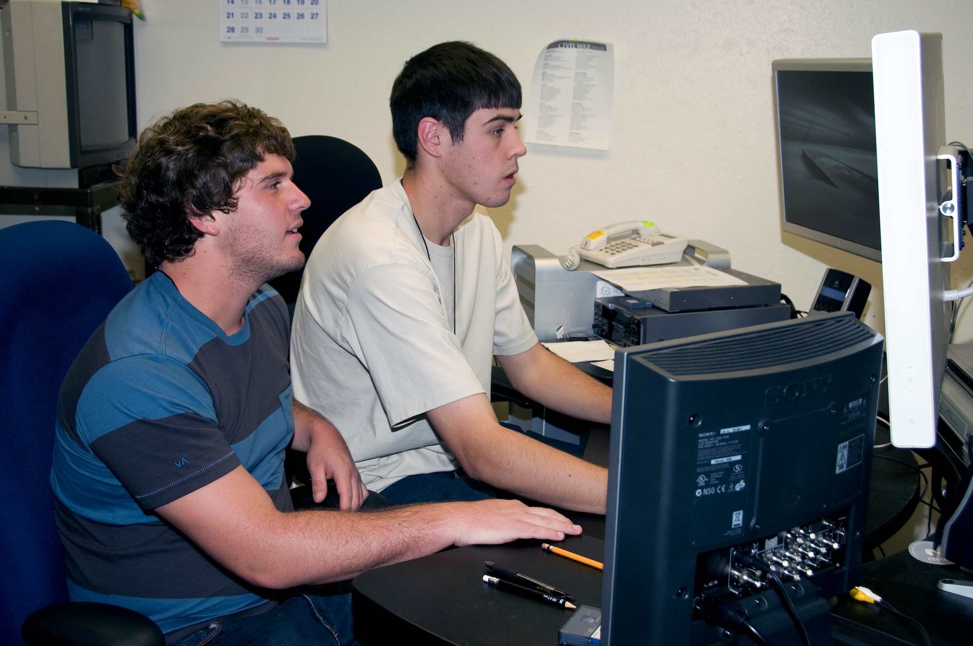 Calum Murray, left, and Ethan Halliday work on editing film footage as part of their duties with the Air Force Operational Test and Evaluation Center Student Intern Program. AFOTEC is partnering with the University of New Mexico for the program aimed at recruiting and training candidates for potential future employment opportunities within AFOTEC, the Air Force, or other government service.