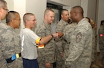 Air Force basic trainees get words of encouragement from Chief Master Sgt. Juan Lewis, 37th Training Wing command chief, during the Mentoring Eats and Leadership event Aug. 25. (USAF photo by Alan Boedeker)                               