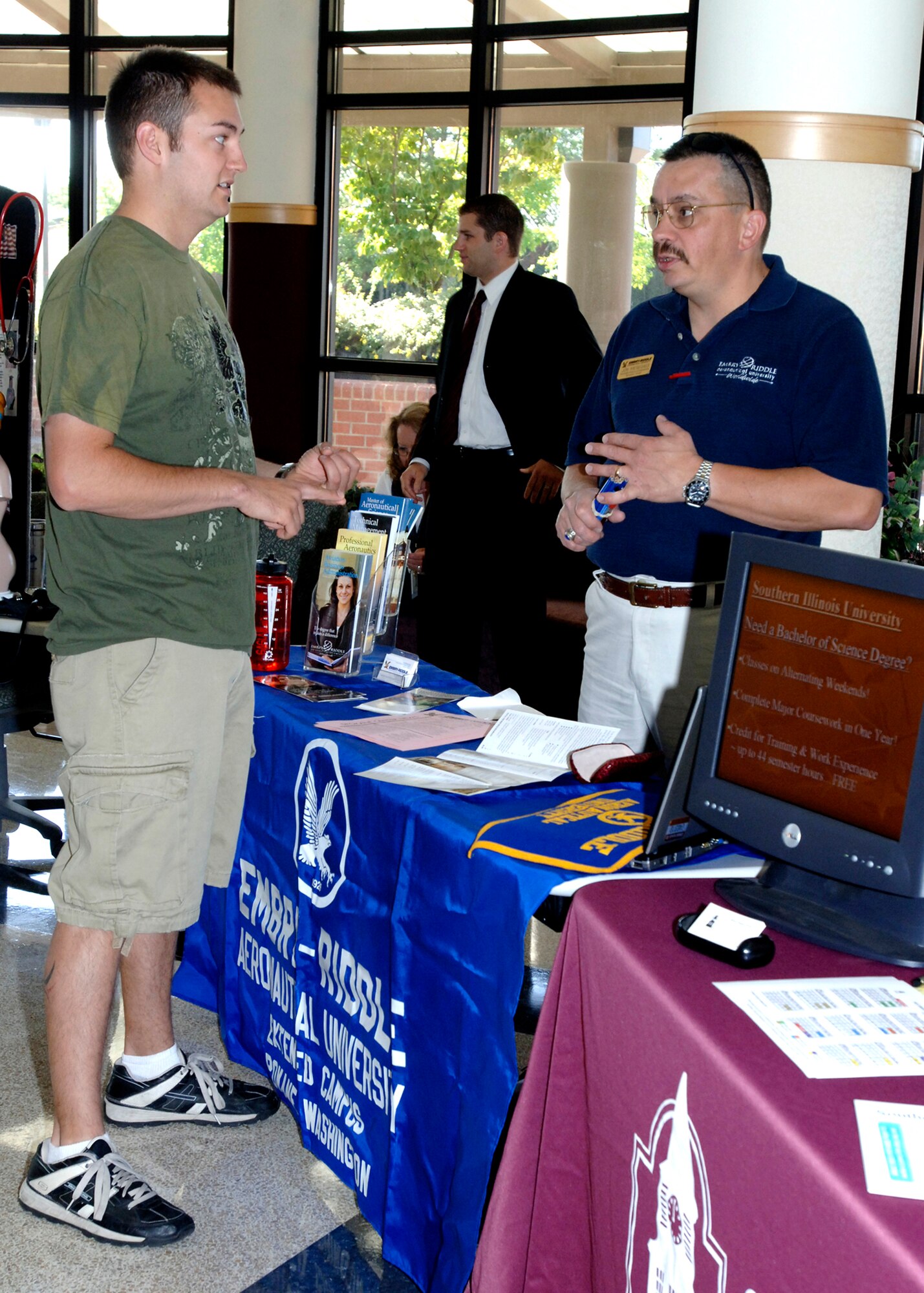 FAIRCHILD AIR FORCE BASE, Wash. – Jon Miesegaes, Embry-Riddle Aeronautical University assistant director of academic support, briefs Staff Sgt. Jon Meller, 141st Air Refueling Wing crew chief, about the career opportunities that Embry-Riddle University has to offer during the Fall Education Fair here Sept. 3. Representatives from local universities were eager to share the programs available to anyone interested in furthering their education. (U.S. Air Force photo / Airman 1st Class Melissa Barnett) 

