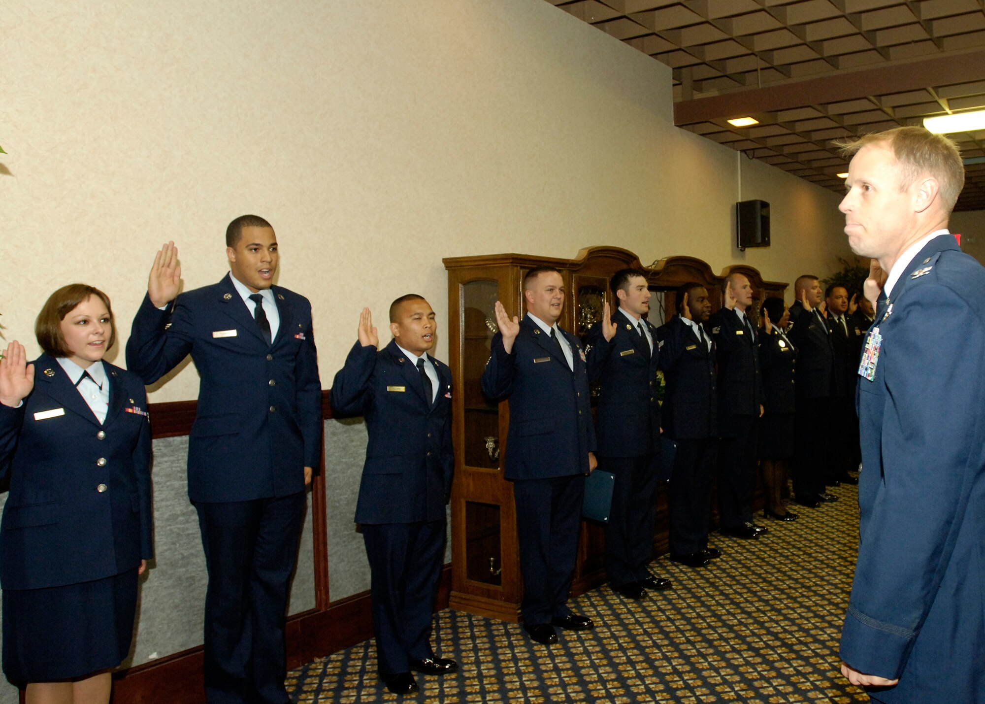 FAIRCHILD AIR FORCE BASE, Wash. -- Col. Blaine Holt, 92nd Air Refueling Wing vice commander, leads Airmen as they repeat their oath of enlistment during the Wing Promotion Ceremony at Club Fairchild Aug. 28. (U.S. Air Force photo / Senior Airman Eunique Stevens)