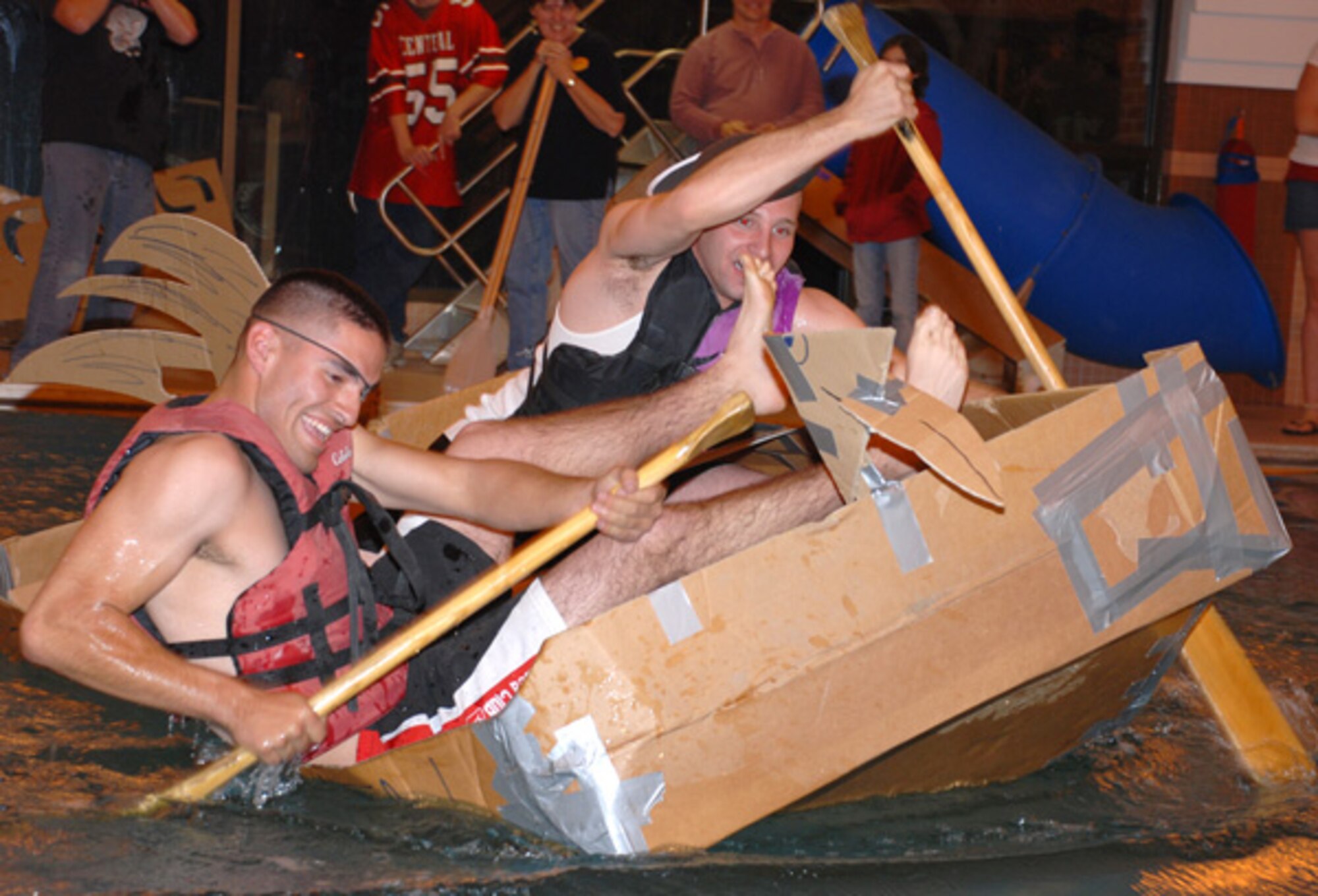 Contestants from last year’s Build-a-Boat competition paddle across Warren’s Aquatic Center’s pool. This year’s competition takes place Saturday.