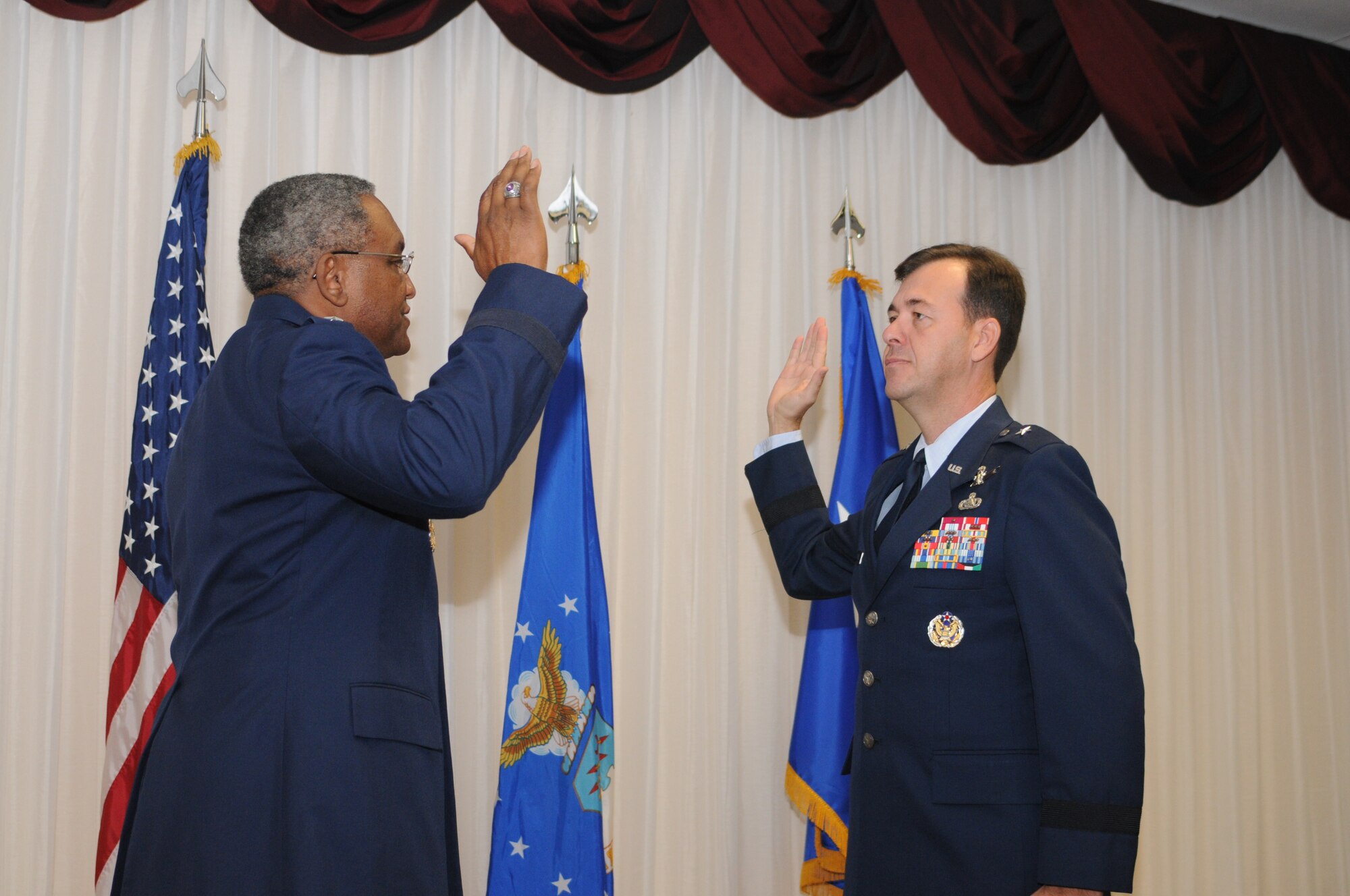 Maj. Gen. Al Flowers, 2nd Air Force commander, administers the oath of office to newly promoted Brig. Gen. Greg Touhill, 81st Training Wing commander. General Touhill's official date of rank is September 2, but the large, formal ceremony was pushed back to September 5 due to the negative weather associated with Hurricane Gustav. (U.S. Air Force photo by Kemberly Groue)