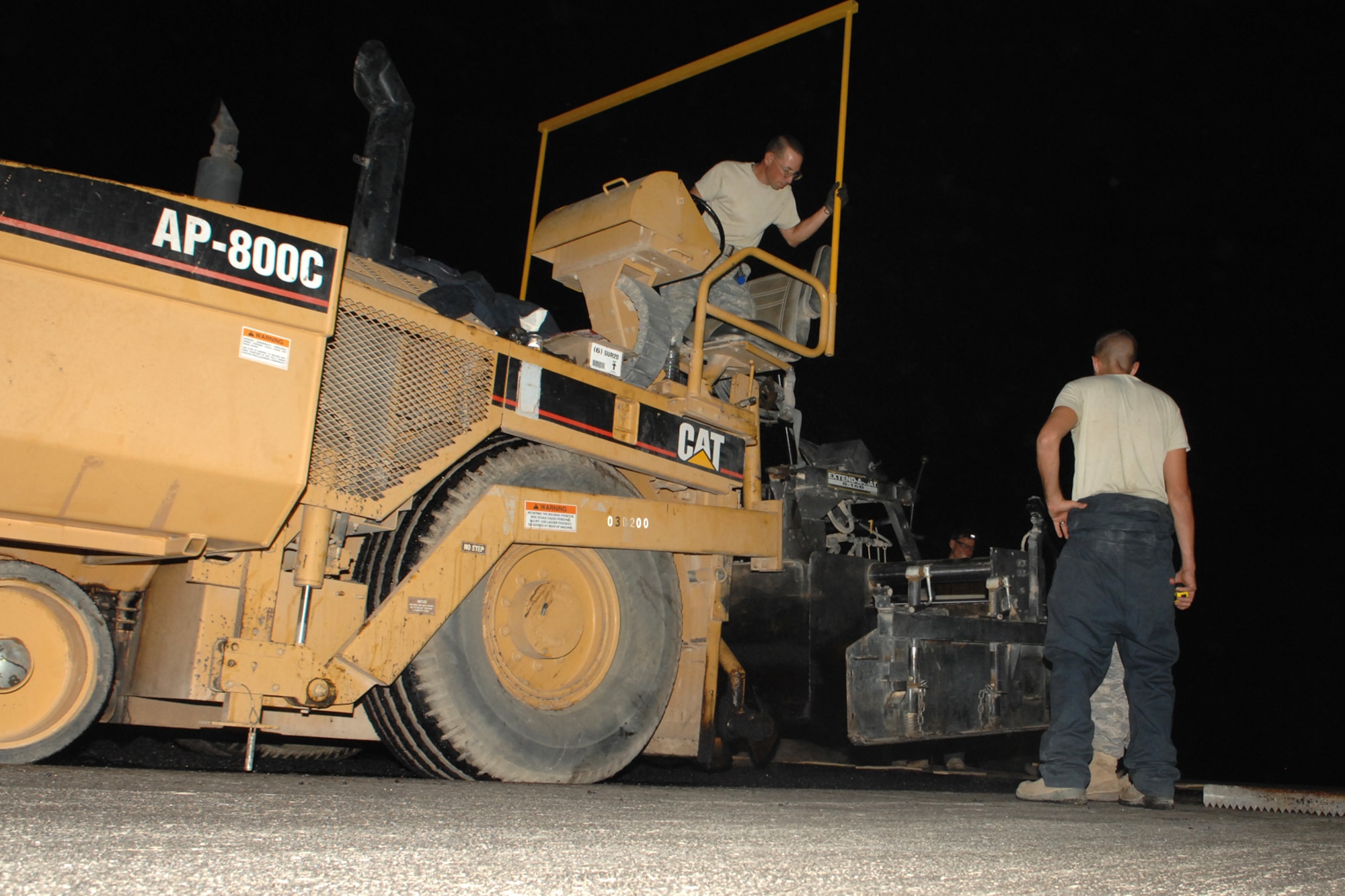 KIRKUK REGIONAL AIR BASE, Iraq -- Staff Sgt. Curtis George, a pavement and construction equipment operator deployed with RED HORSE, operates a paving machine here recently.  The RED HORSE team is made up of Airmen from around the Air Force who are here for approximately 90 days to repair the runway.  The team will lay nearly 38,000 tons of asphalt and will have milled nearly 1.3 million square feet of the runway by the end of the project scheduled for Oct 1.  The project will help reduce FOD and eliminate cracks and potholes of the old surface.  Sergeant George is deployed from Seymour Johnson Air Force Base, N.C., and calls Eunice, La., home. (U.S. Air Force photo/Senior Airman Randi Flaugh)

