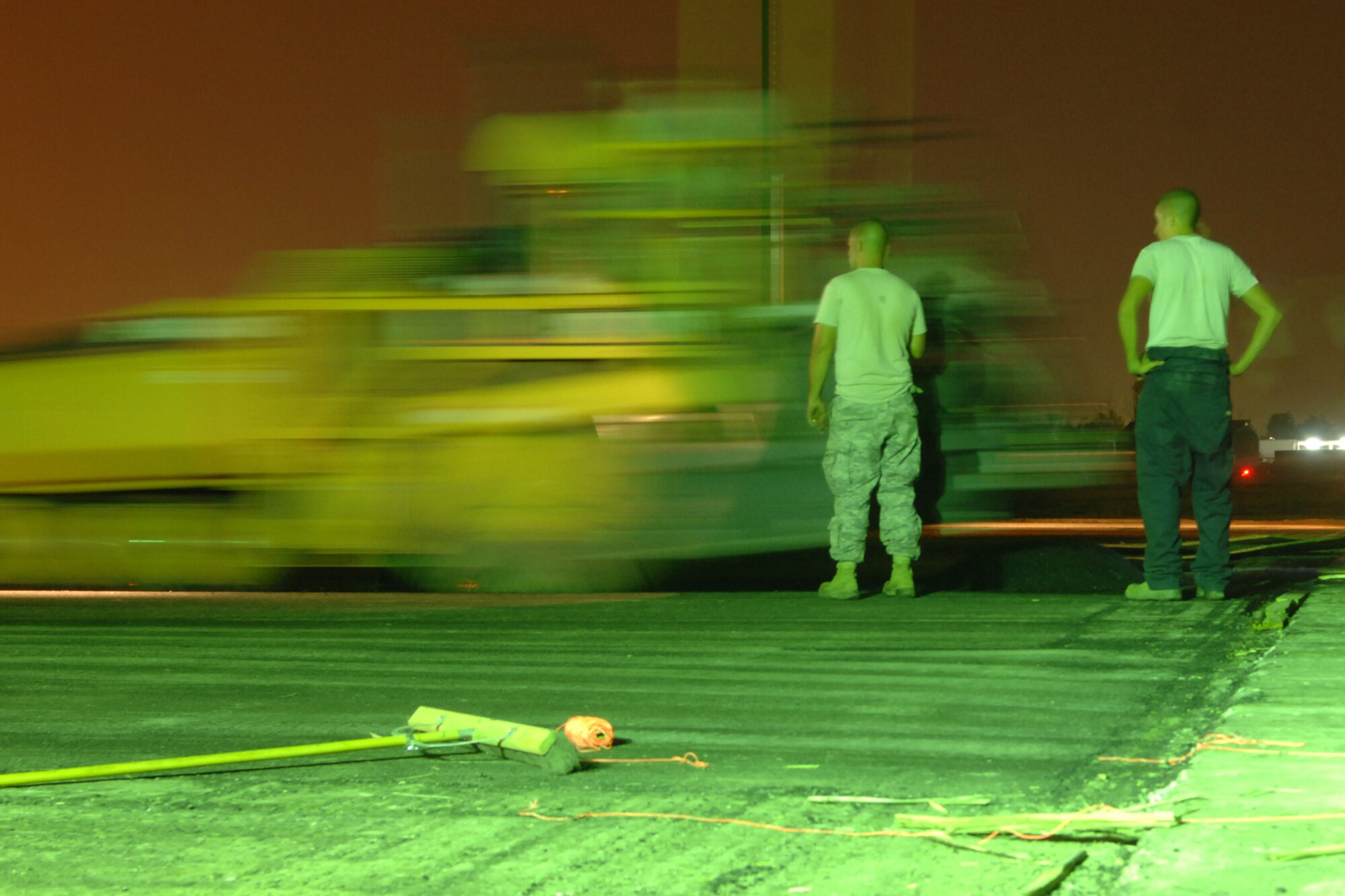 KIRKUK REGIONAL AIR BASE, Iraq -- RED HORSE Airmen begin to lay asphalt on a runway here recently.  The team is made up of Airmen from around the Air Force who are here for approximately 90 days to repair the runway. The project will help reduce FOD and eliminate cracks and potholes of the old surface.  They've completed the milling of 1.3 million square feet of runway and are in the process of laying down 38,000 tons of asphalt.  The job is due to be completed Oct 1. (U.S Air Force photo/Senior Airman Randi Flaugh)
