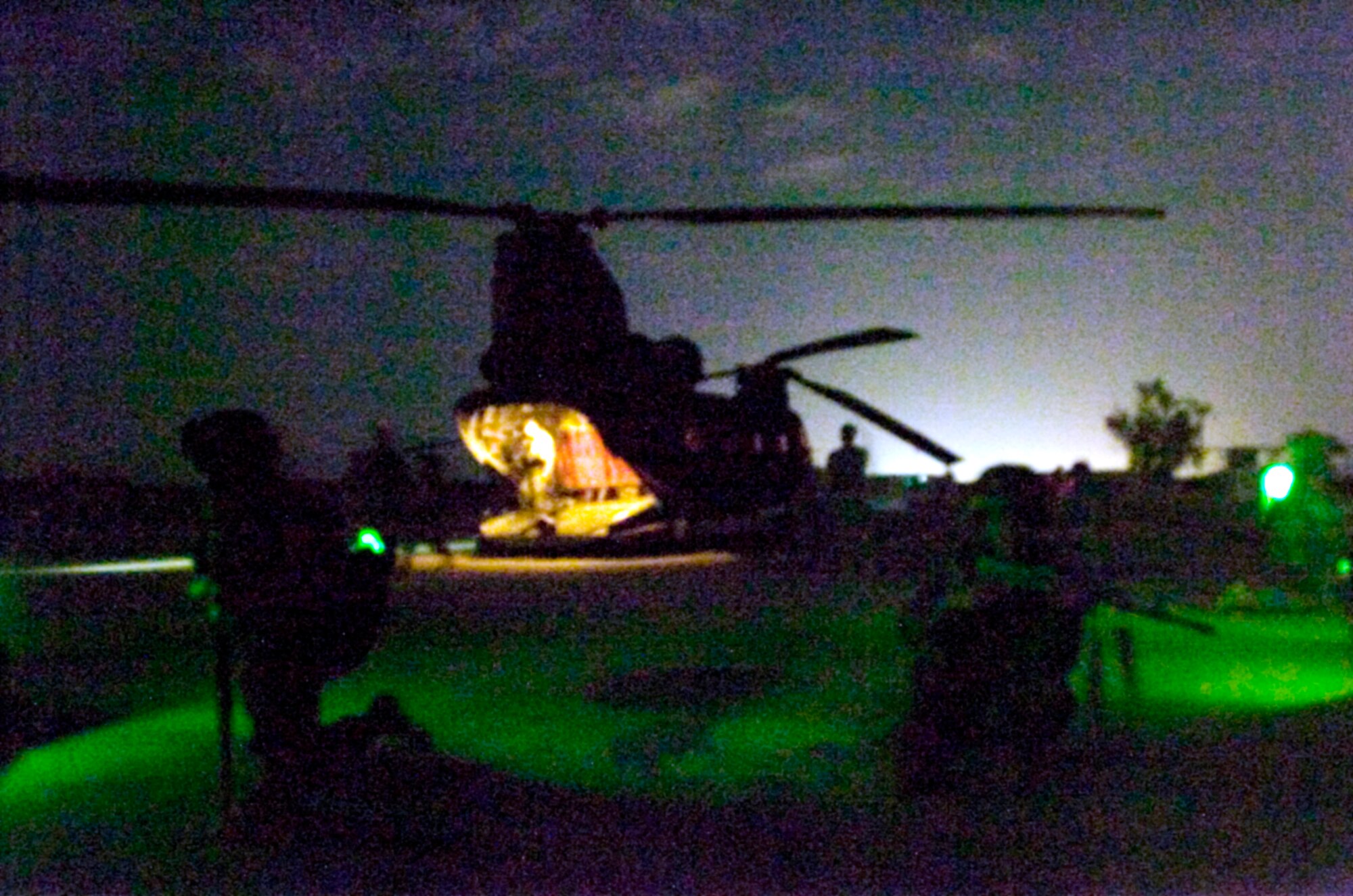 U.S. Soldiers from the 2nd Battalion, 320th Field Artillery Regiment, and Iraqi soldiers from the 3rd Battalion, 17th Brigade, prepare to load onto a CH-47 Chinook helicoopter near Joint Base Balad, Iraq, for a joint air assault mission Aug. 11. The nighttime air assault was designed to train Iraqi Security Forces in how to conduct night operations under low-light conditions. (U.S. Army photo/Staff Sgt. Tim Sander)